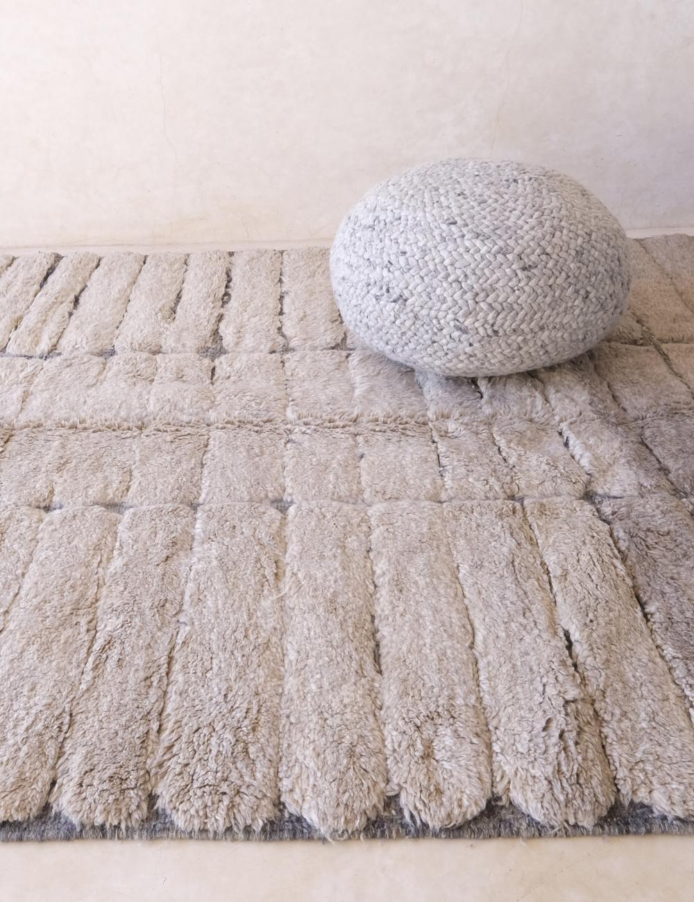 This impressive, neutral handwoven Moroccan rug was made by hand by skilled artisans in the Atlas Mountains. It features high quality M'Rirt wool, and is the perfect neutral statement piece with a unique engraved design which showcases advanced