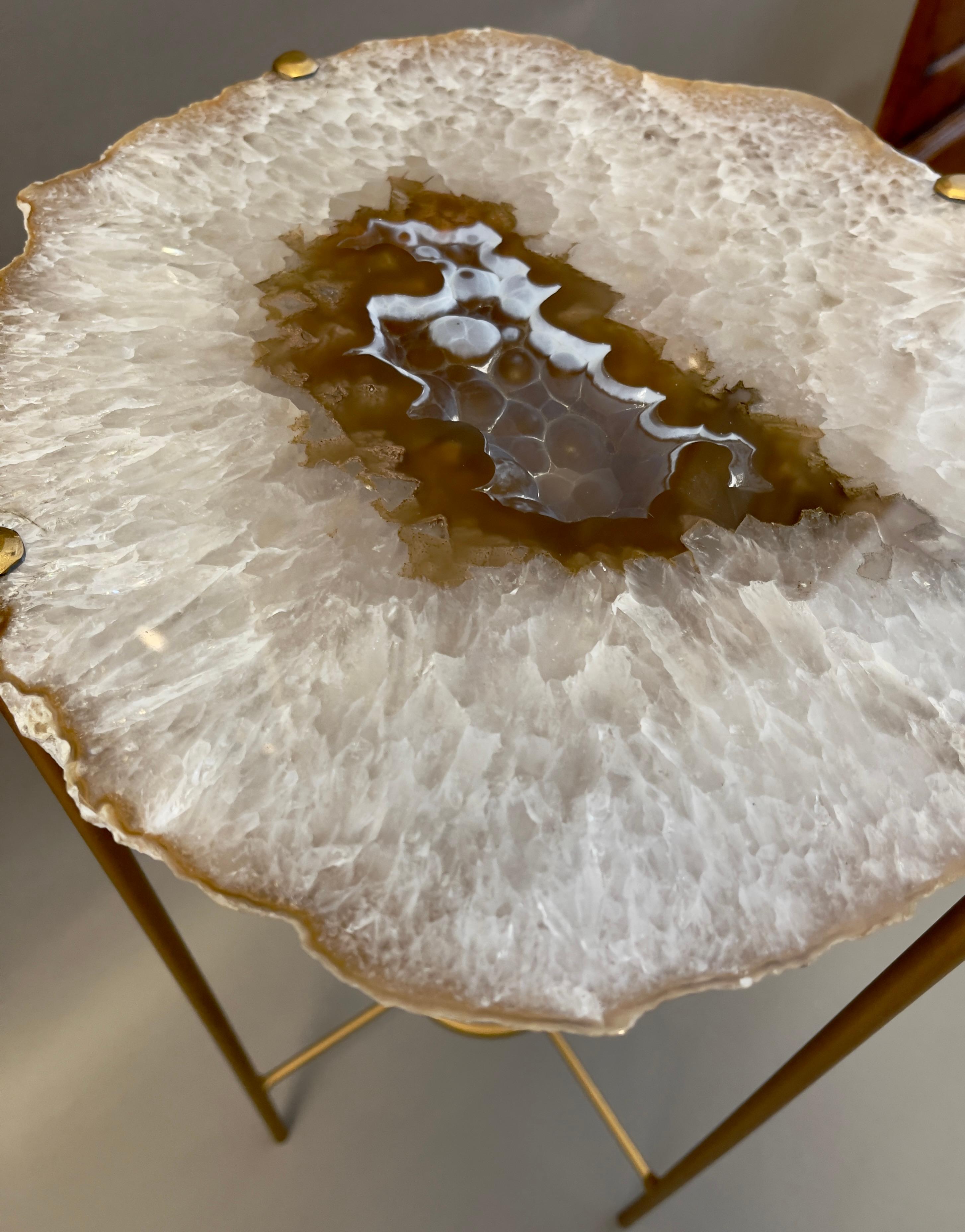 Our gorgeous geode drinks tables are a perfect addition to any room, but particularly when light catches them just right. Each Agate surface unique in color, points of interest and shape.

Handcrafted with polished quartzite slabs atop a gilt