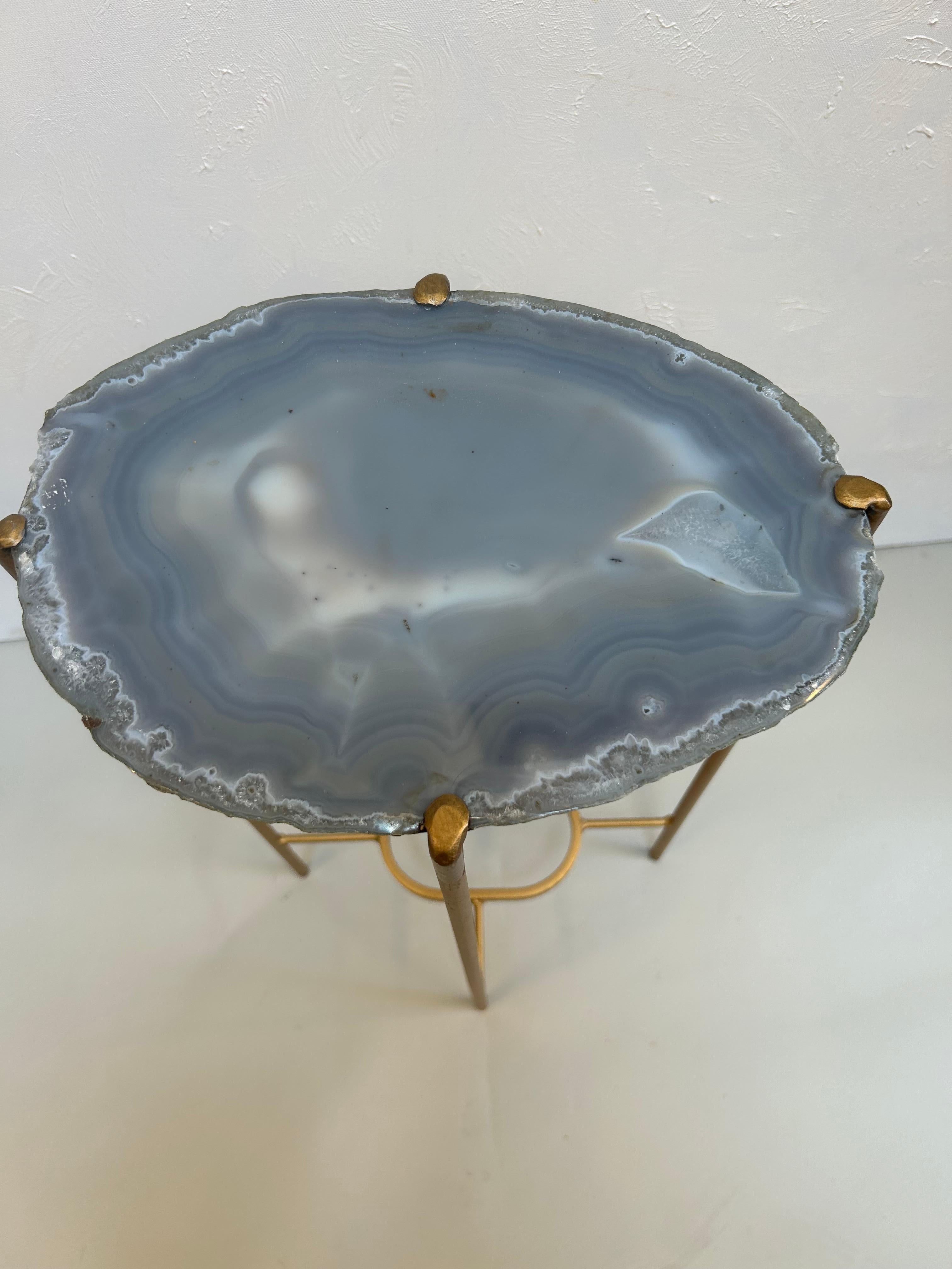 Elevate your space with this handcrafted geode drinks table by Hastening Designs, made in the USA in the 2020s. Featuring a one-of-a-kind natural quartzite slab top, each piece showcases mesmerizing crystalline formations and unique color banding in