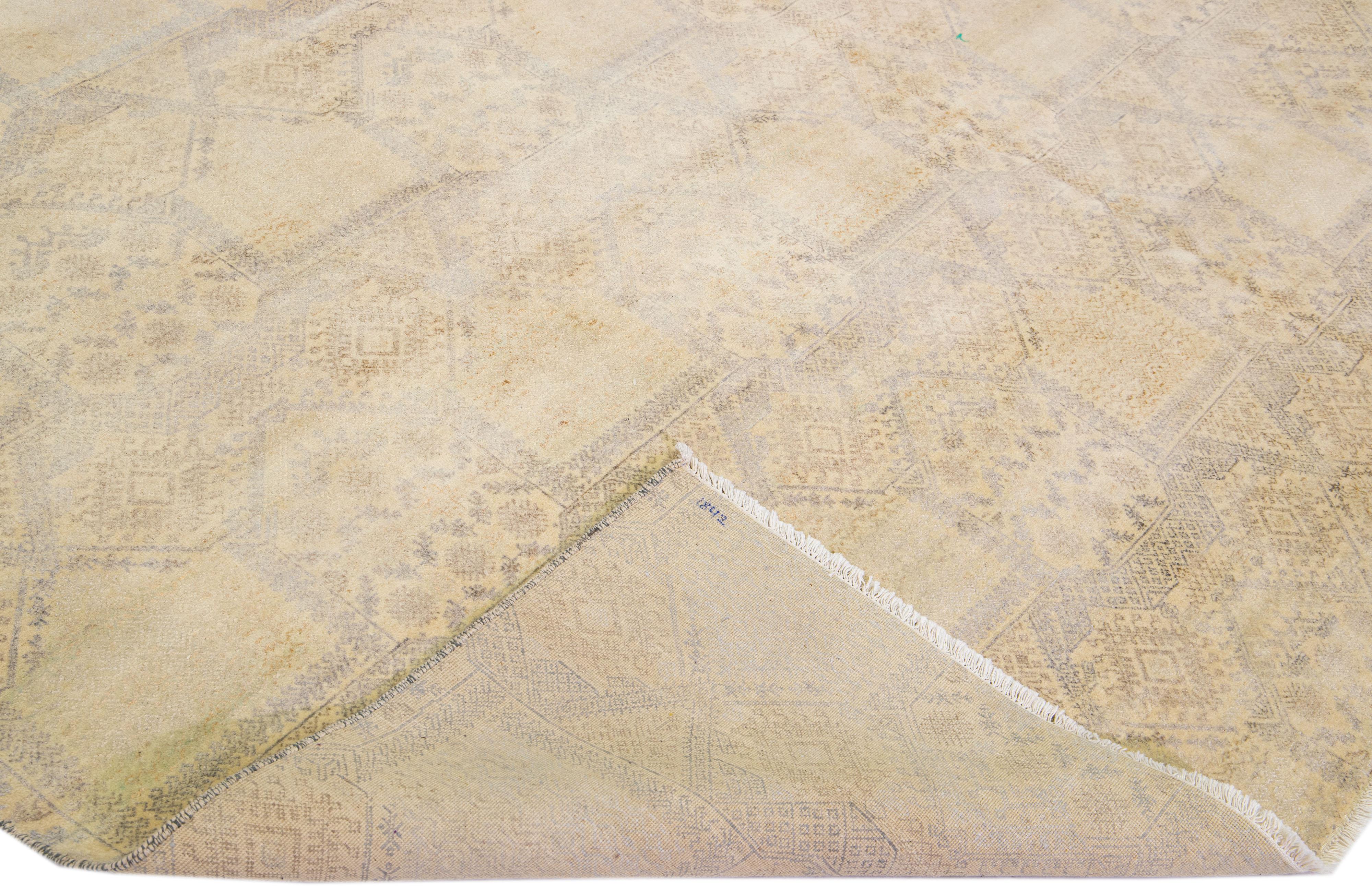 Beautiful Contemporary hand-knotted Indian wool rug with a detailed beige field. This rug has gray color accents in an all-over geometric pattern design.

This rug measures: 11'9