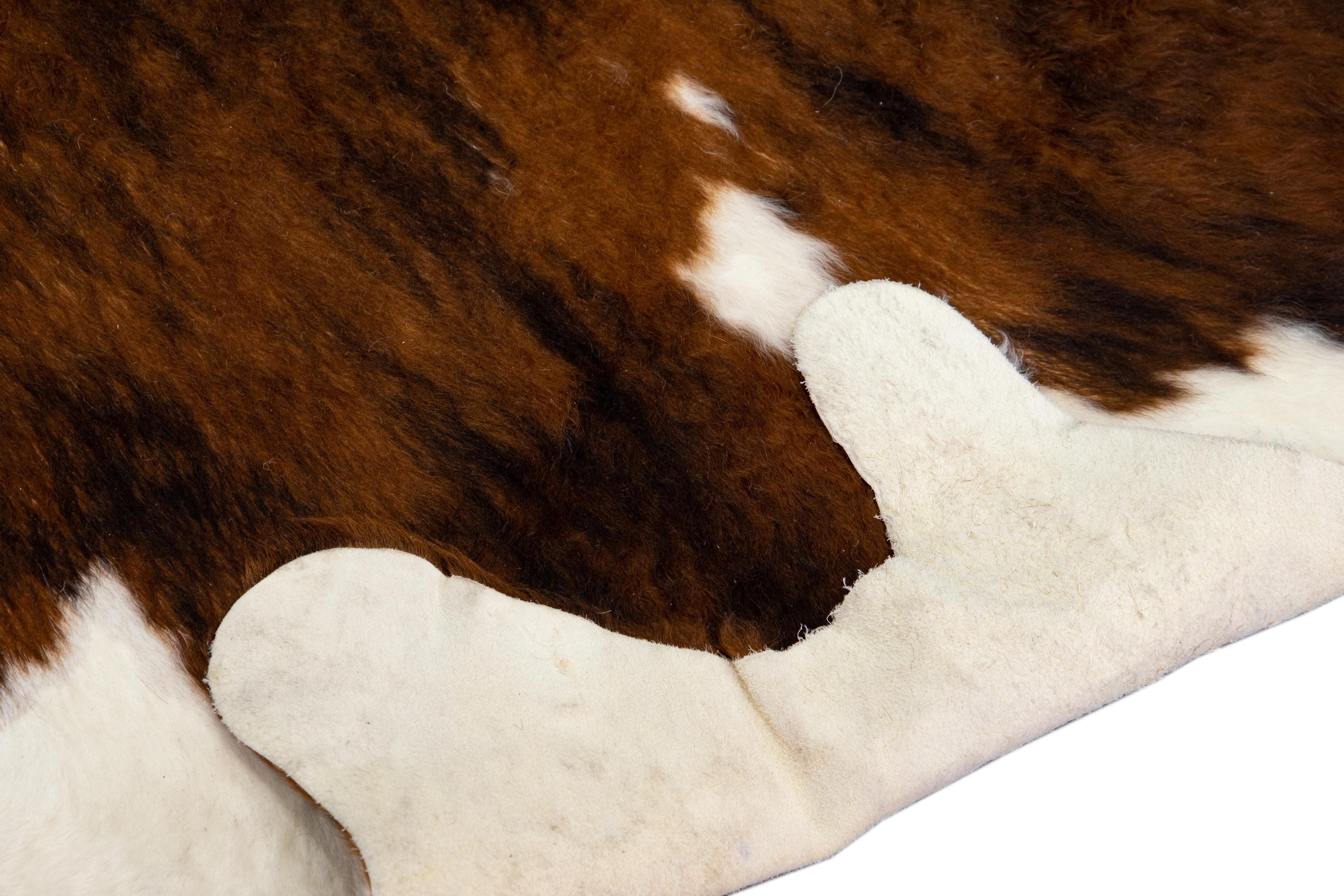 This beautiful modern Cowhide rug adds a rustic charm to any space in your house and can be used as a floor carpet, a couch throw, or even a wall decor. Cowhides are known for their soft feel underfoot. Add a touch of cozy to any room with this