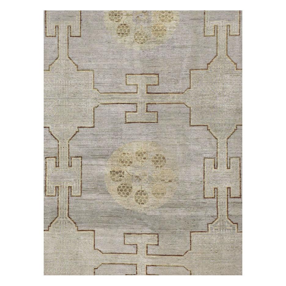 A modern Khotan large room size carpet handmade during the 21st century in shades of beige and greyish purple.

Measures: 13' 9
