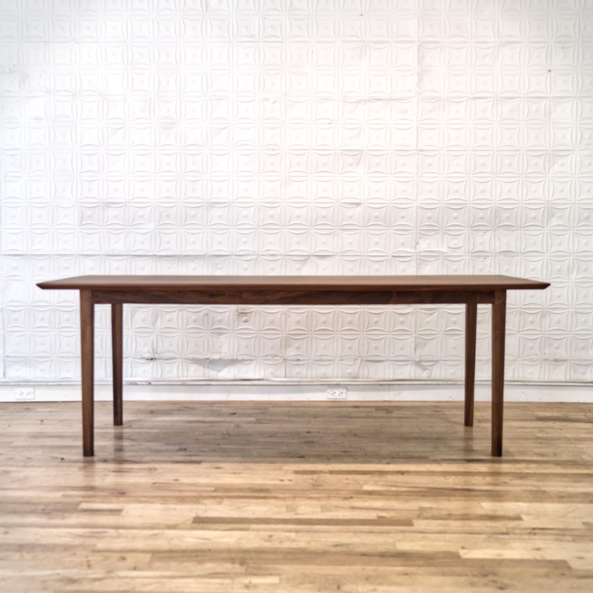 This molten grain walnut table spans in magical chamfered edges.
Handcrafted in solid walnut with tapered legs, a perfect setup for a dining table or large artist desk.
Benches are sold separately.


Own a figure ground