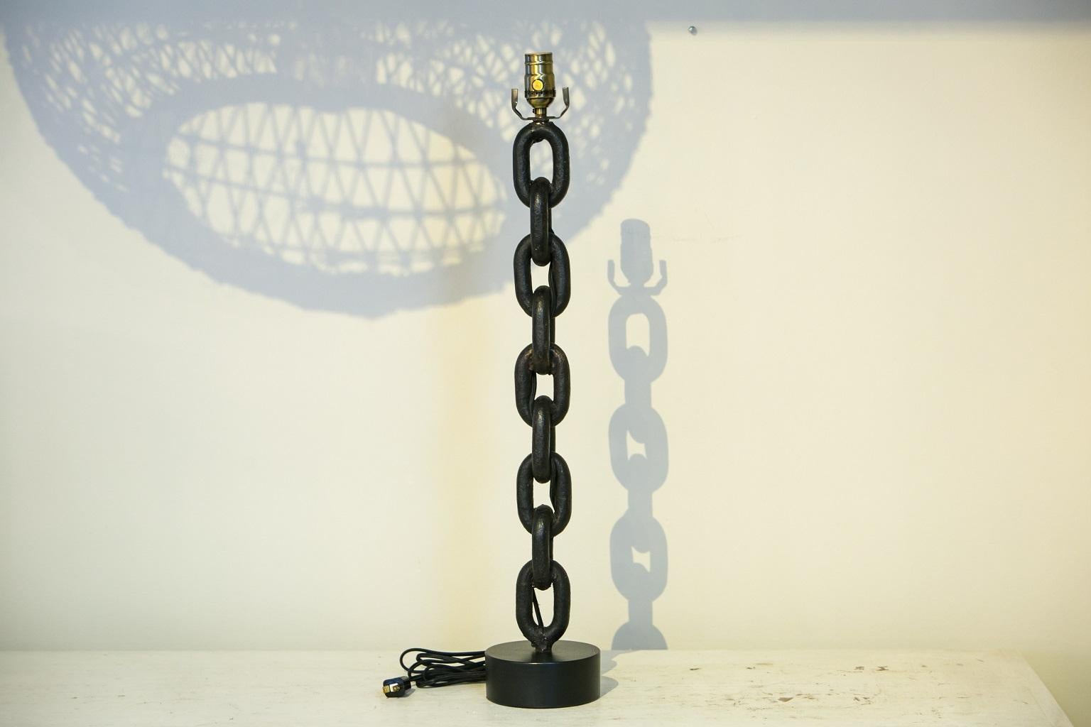 Handmade iron chain table lamp from Belgium. Hand-hammered iron chain links newly wired as a custom table lamp (for use within the USA). Chain's patina is beautiful and lamp stands a total of 29 inches high to top of socket (including base). Lamp