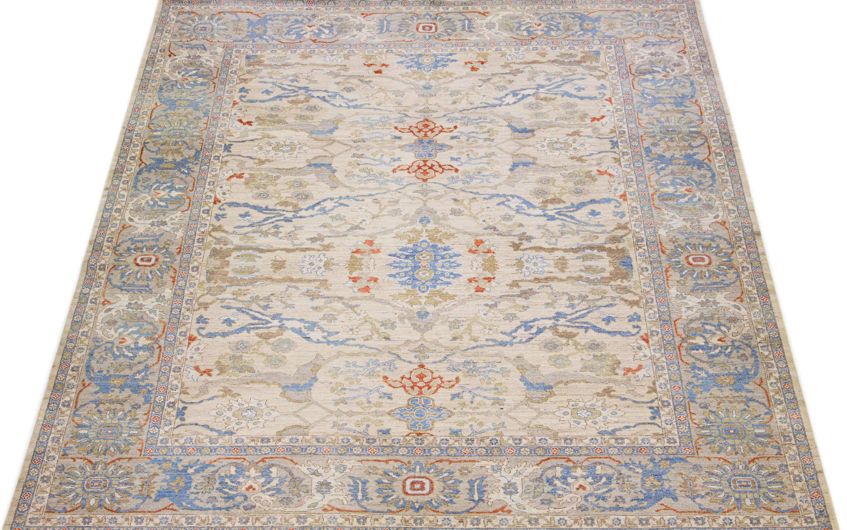 This hand-knotted wool rug showcases an exquisite modern Oversize Sultanabad design in a stunning beige color palette. Its intricate frame features captivating accents in rust, blue, and brown hues arranged in a remarkable all-over pattern.

This