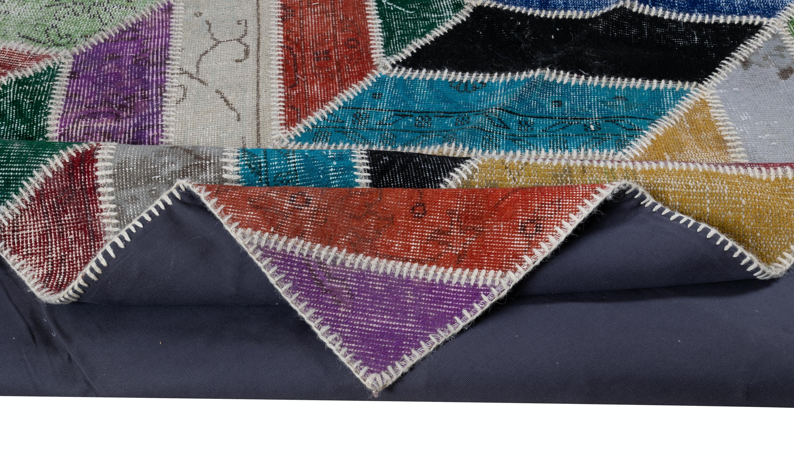 Assorted pieces of vintage hand-knotted Turkish carpets were washed, sheared, re-dyed in various colors, cut into geometric shapes then stitched together by hand to create this beautiful one of a kind patchwork rug. 
A durable dark color cotton