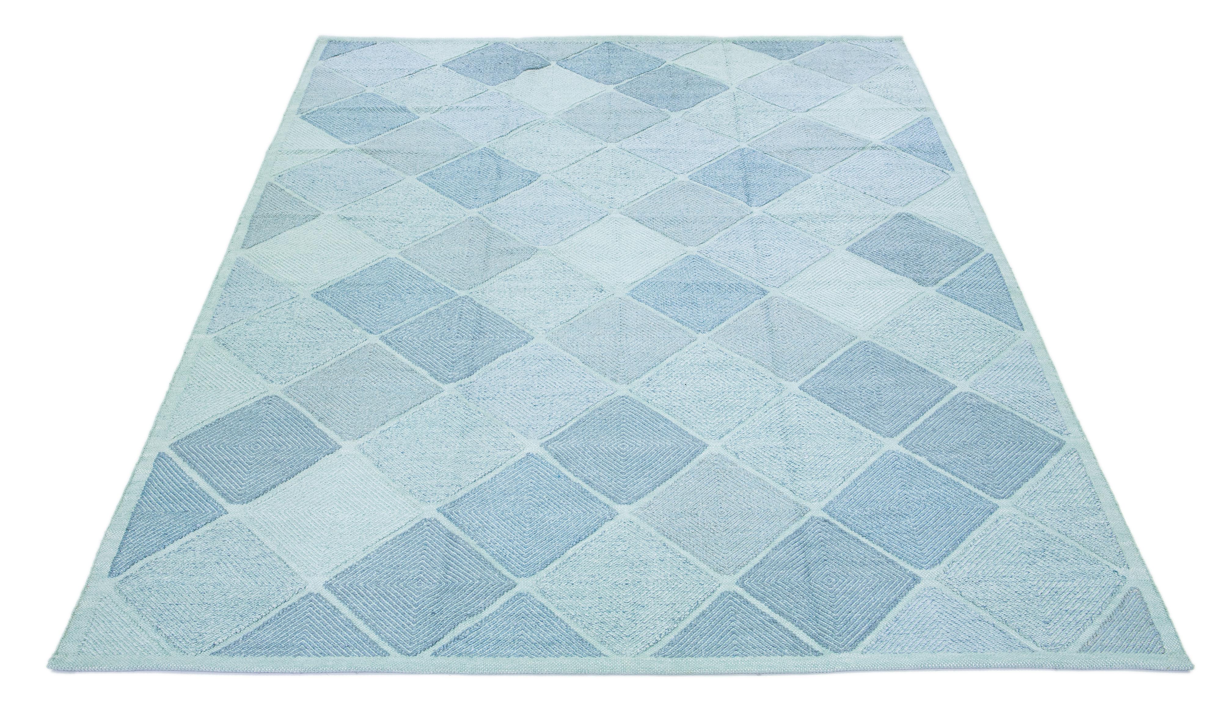 Beautiful modern Swedish-style wool rug with a Turquoise-blue field. This Swedish rug has a gorgeous all-over geometric pattern design.

 This rug measures: 10' x 14'2
