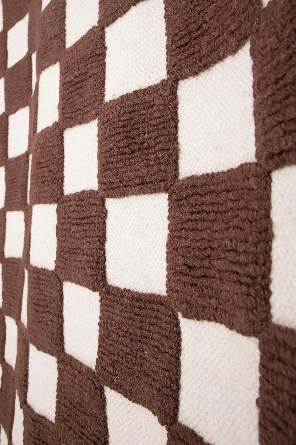 This rug has been ethically hand woven in the finest wool yarns by artisans in north of India, using a traditional weaving technique which defines the design.
The white part is handwoven in flatweave with a thickness of 6mm and the brown part is