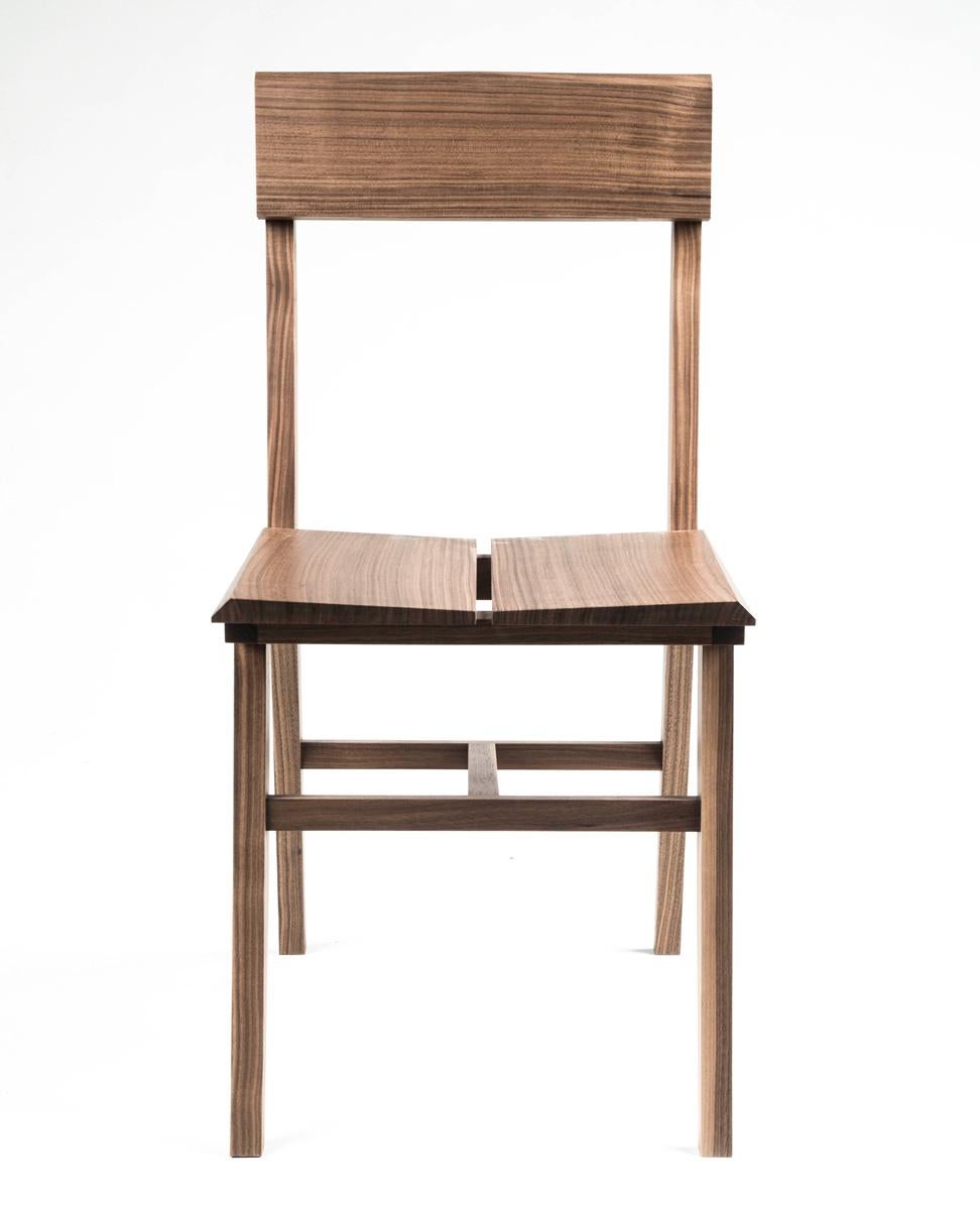Place this hardwood modern Rift chair around your table or in your office. Hand-cut lap joints on the profile and mortise and tenon construction make this chair the perfect blend of beauty and brawn. 

This listing is for a Rift chair in walnut.