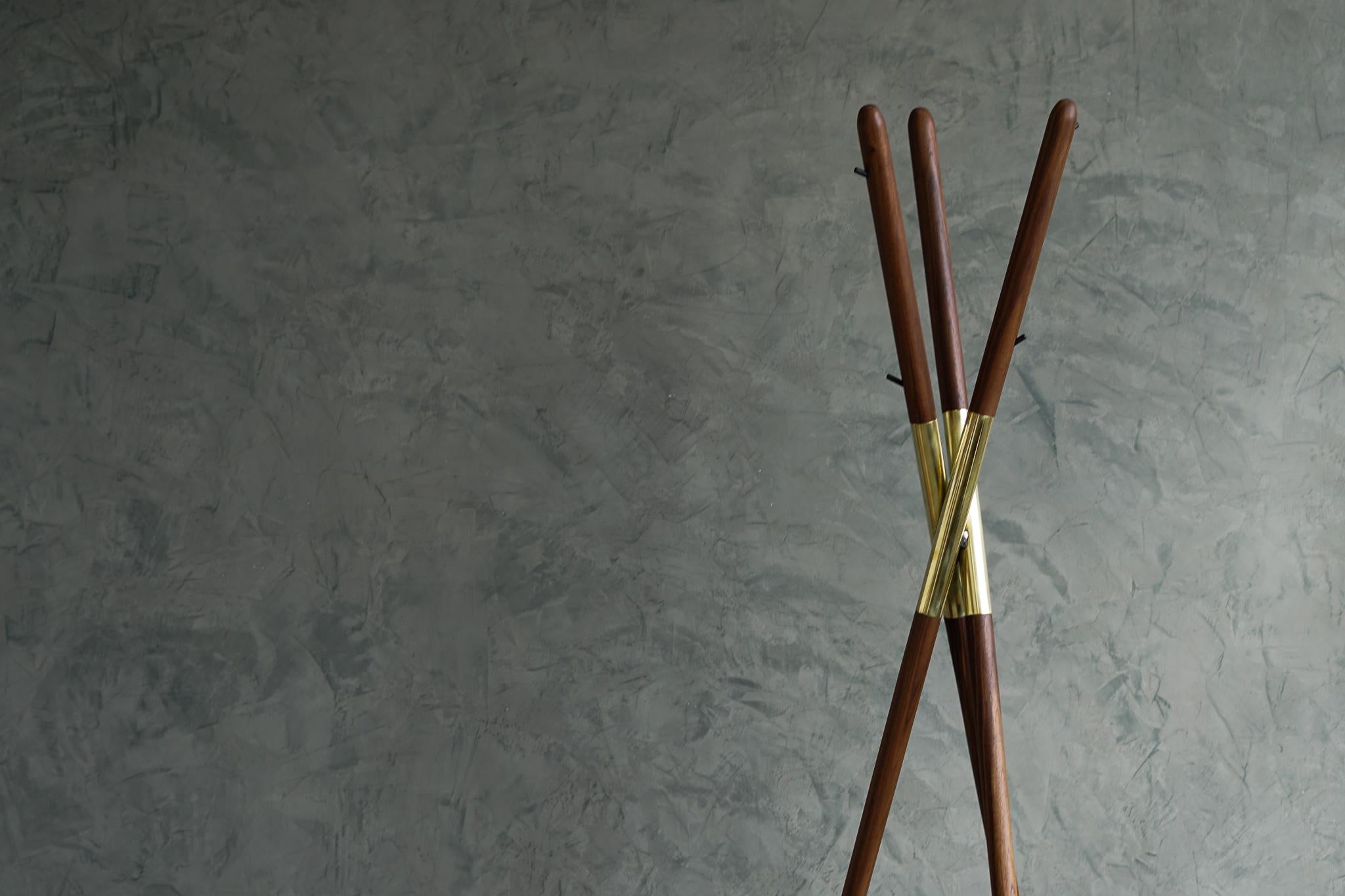 The Hashi coat rack is designed after a widely known tool, the chopsticks. Created from walnut and polished brass. The Hashi mimics the simplicity and timelessness of this ancient tool used daily by millions around the globe.
