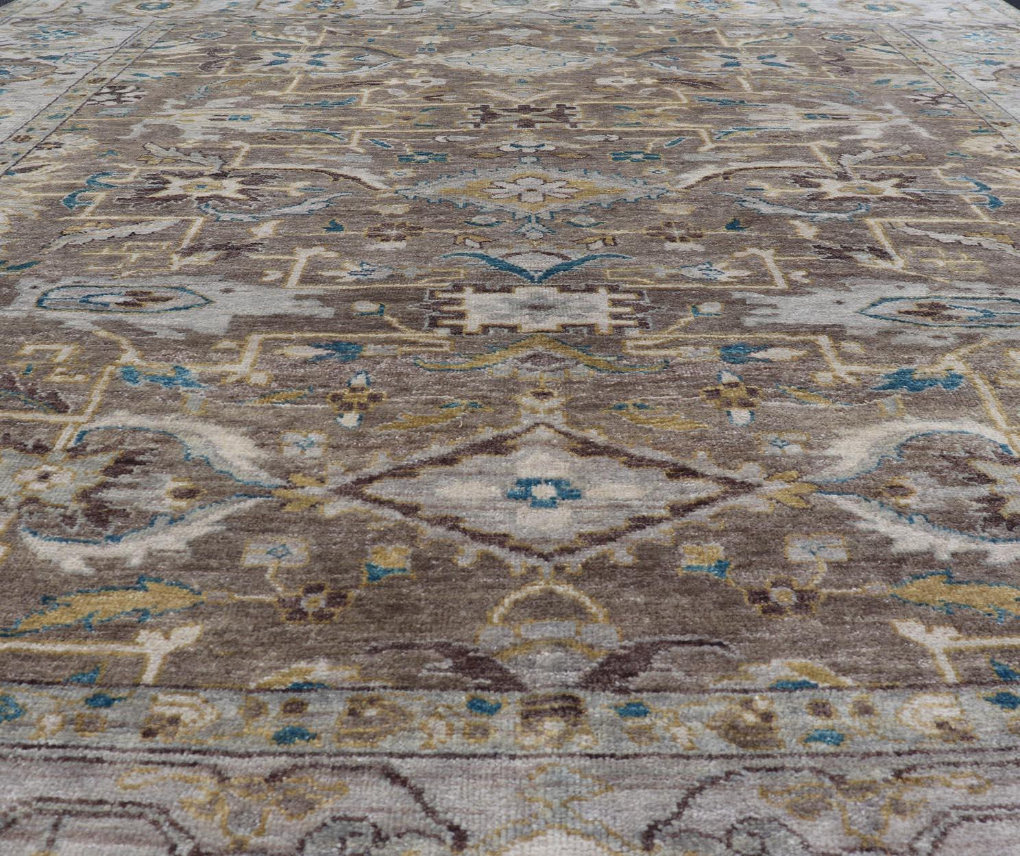 Measures: 9'0 x 10'6 
Modern Heriz Geometric Rug in Earthy Browns and Soft Blues  9'0 x 10'6. 
Keivan Woven Arts/ Rug/OB-9313050. Country of Origin / type: India / Heriz. 

The rug showcases a harmonious combination of earthy browns, soft blues,