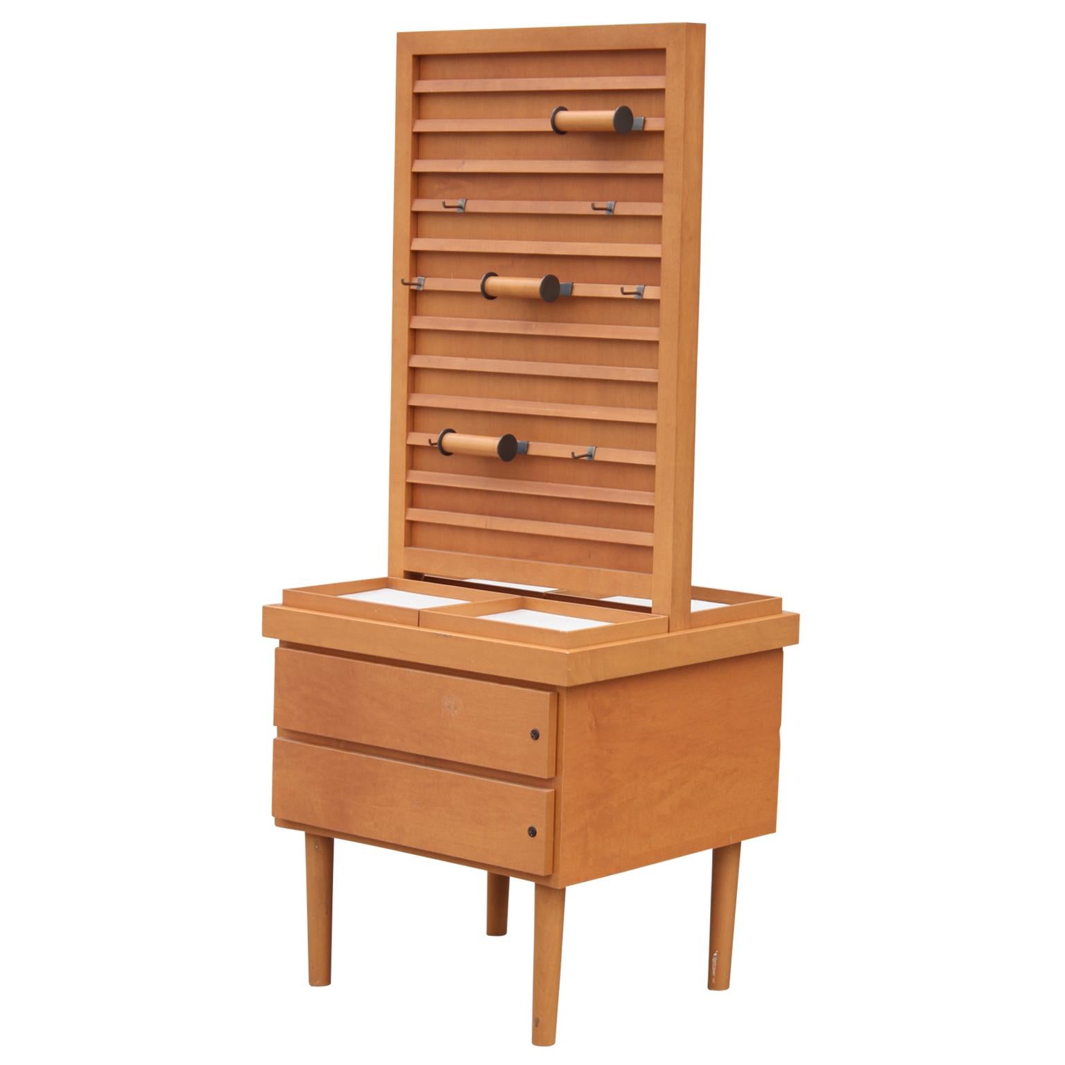 Gorgeous modern and unique display stand or adjustable rack in the style of Hermès. This piece features two drawers with dividers and an adjustable rack perfect for storing or displaying jewelry, ties etc. Believed to be made out of pearwood.