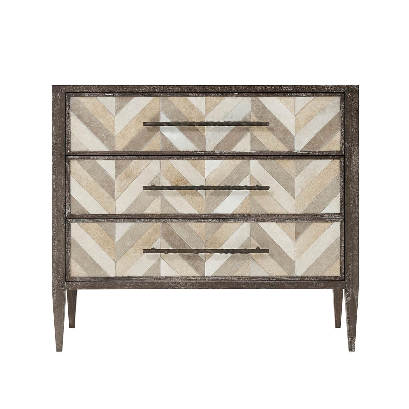 Modern three drawer herringbone parquetry and mesquite finish mahogany dresser. Each drawer is covered with hair-on-hide and with cast brass handles and self-closing drawers.

Dimensions: 39