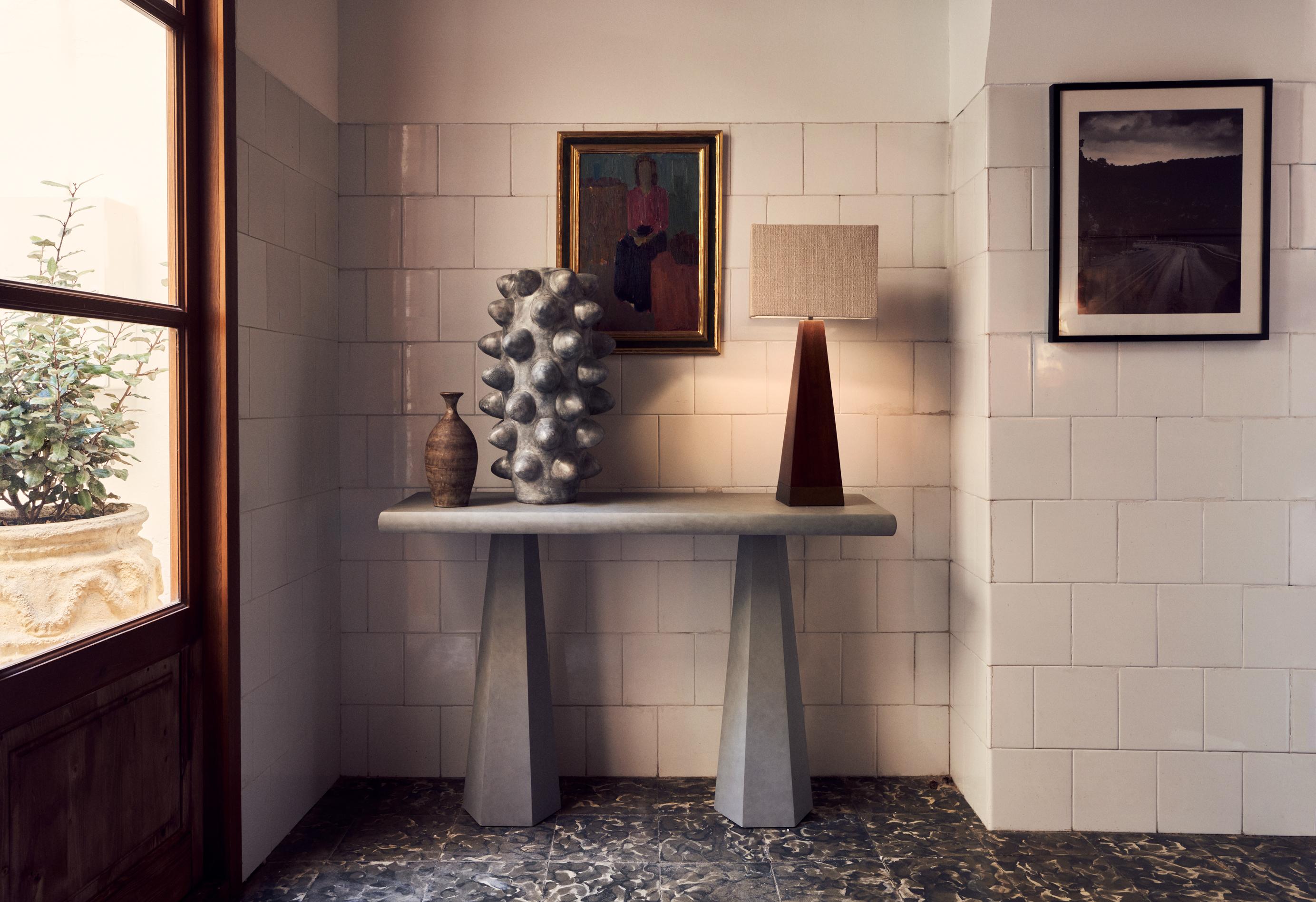 A small console table that fits perfectly in your hallway or use it a small side table with a nice lamp on it. We love the idea to pair it with our hexagon table lamp. Comes in cultivated mahogany or a concrete finish made out of layers of plaster