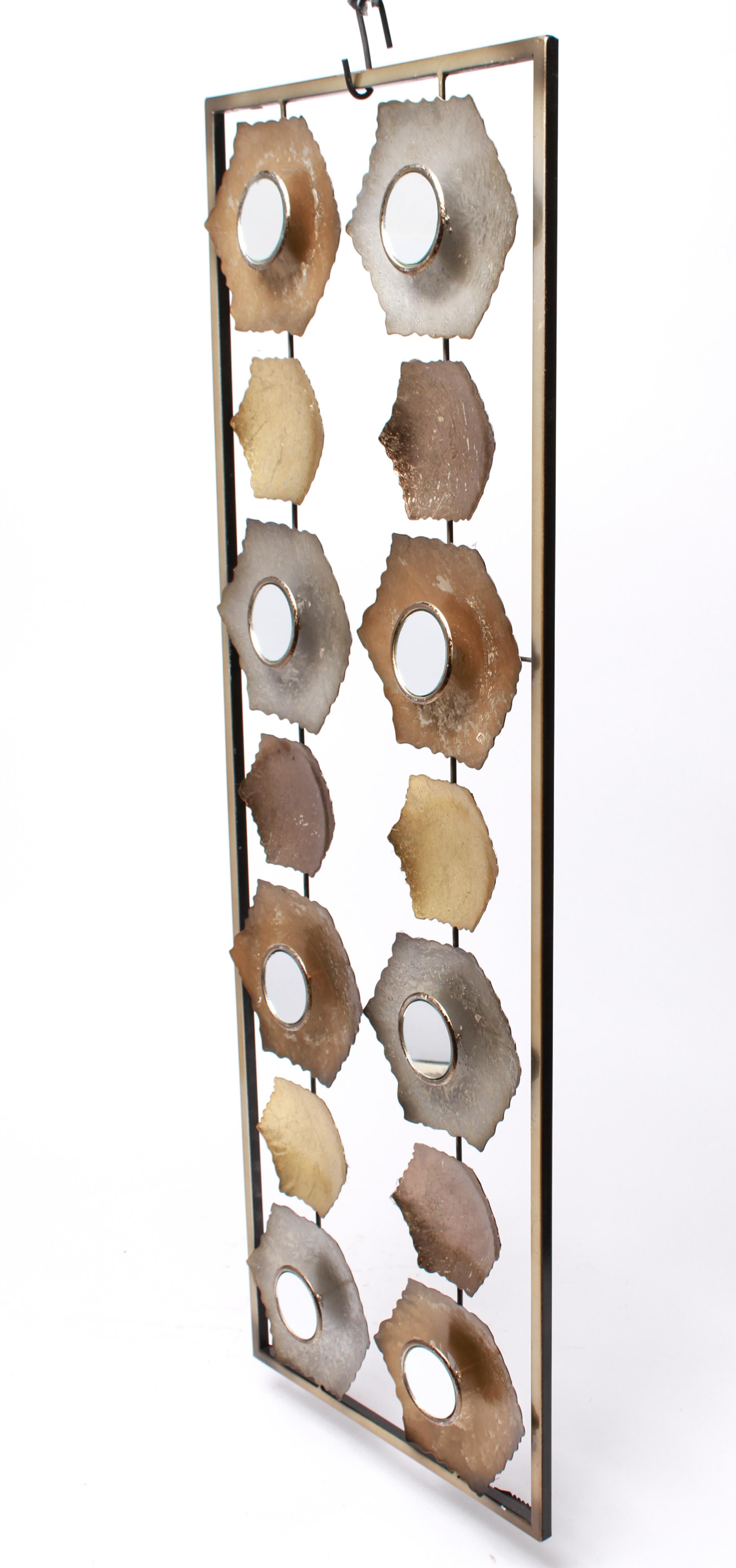 Modern metal wall sculpture composed of two columns of hexagons, several with round mirrored panel inserts. The piece is in great vintage condition with age-appropriate wear and use.