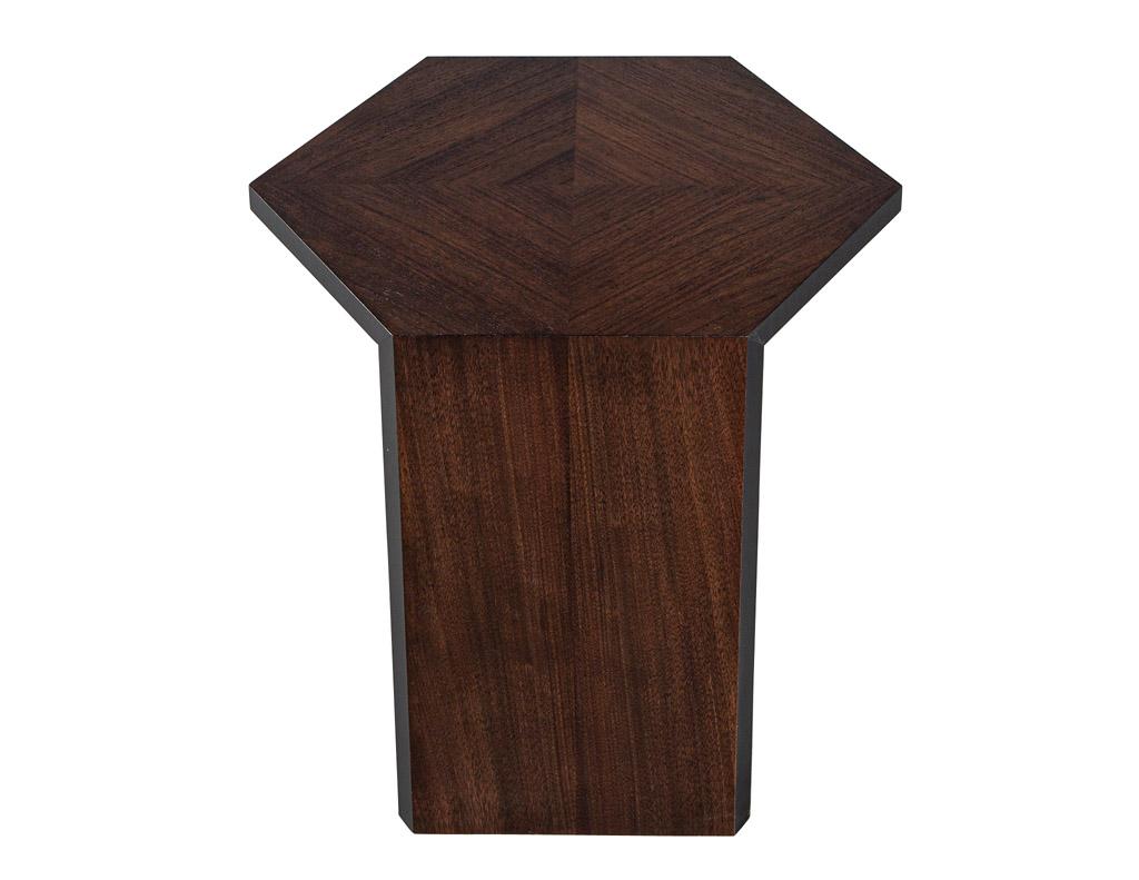 The Modern Walnut Accent Table. Crafted from high-quality walnut wood, this hexagonal-shaped table boasts a sleek and contemporary design that will elevate the style of any room. The unique open design of this accent table adds a touch of elegance