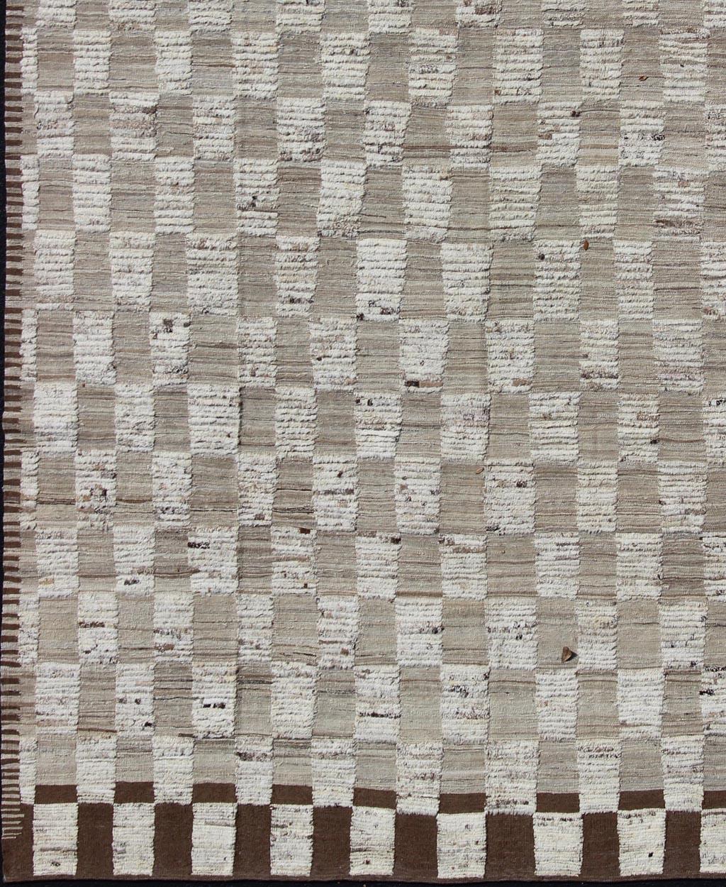 Hi-Low Piled Rug With Checkerboard Design in Earth Tones by Keivan Woven Arts

Measures: 9'6 x 12'6

Hi Low pile rug, combination of Kilim and pile Rug with Checkerboard Design in Earth Tones,
Shades of Taupe Modern Rug with Kilim-Piled Texture,