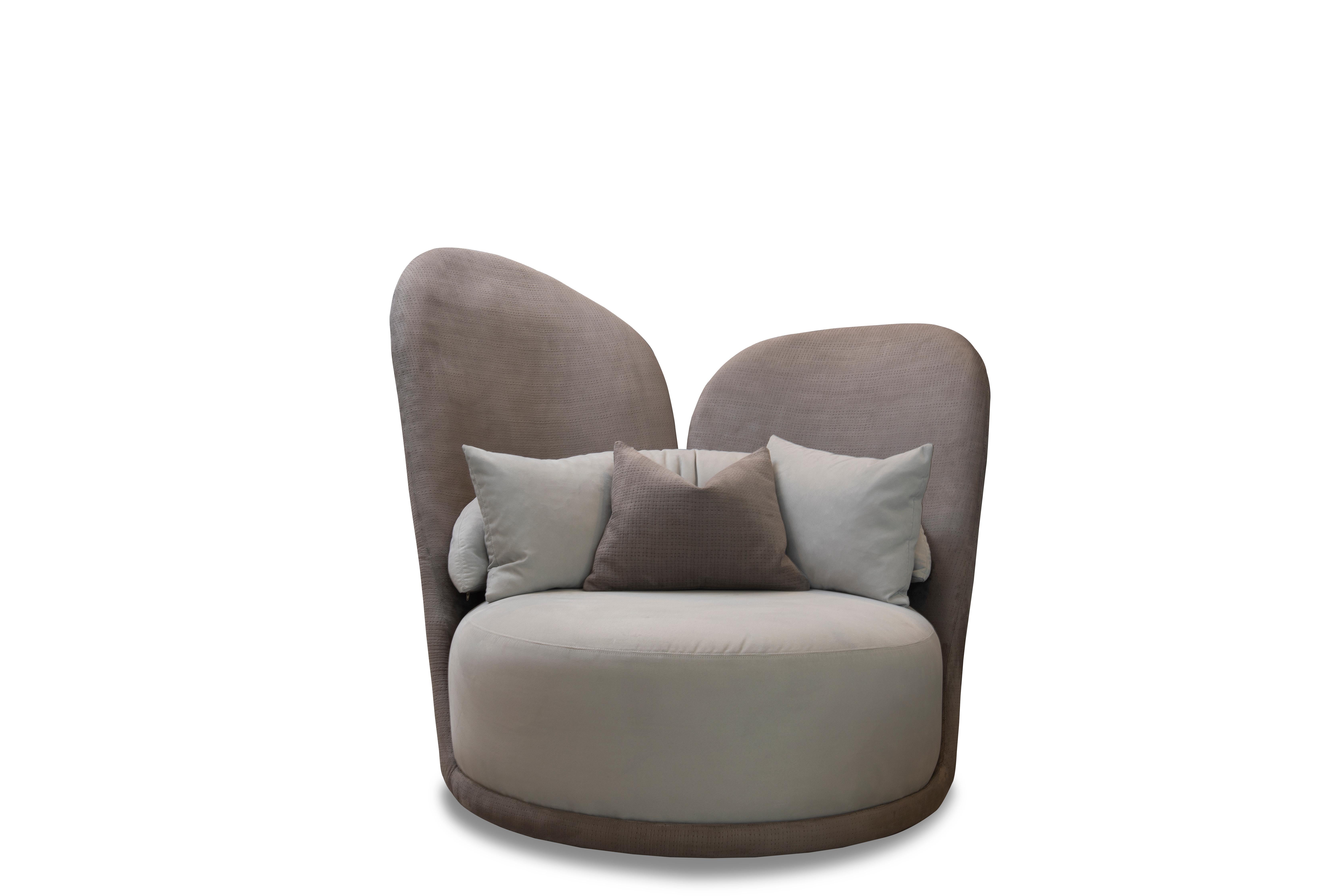 COCÓ is the fusion of armchair and sofa with an extra high iconic back and a large comfortable seating area. The unique shape invites you to retreat into your cozy private world – cuddle up with a good book or your love. 

As shown Body: Lux
