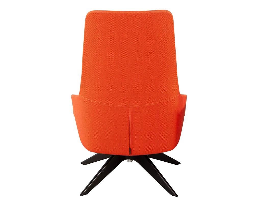 Modern high back Swivel chair by Andreu World. Featuring textured burnt orange fabric with oversized seat and tall back. Able to pivot left and right, sitting atop a black 4 legged pedestal. A perfect chair for an office or lounge setting.

Price