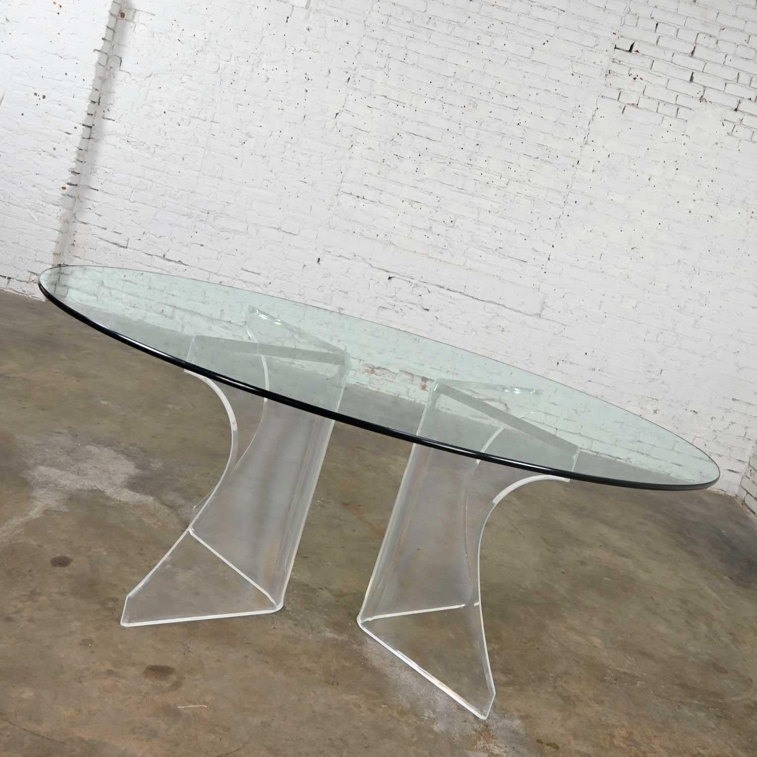 Gorgeous vintage modern Lucite sculptural dining table with oval shaped glass top. Beautiful condition, keeping in mind that this is vintage and not new so will have signs of use and wear. The Lucite has been professionally polished and is wonderful