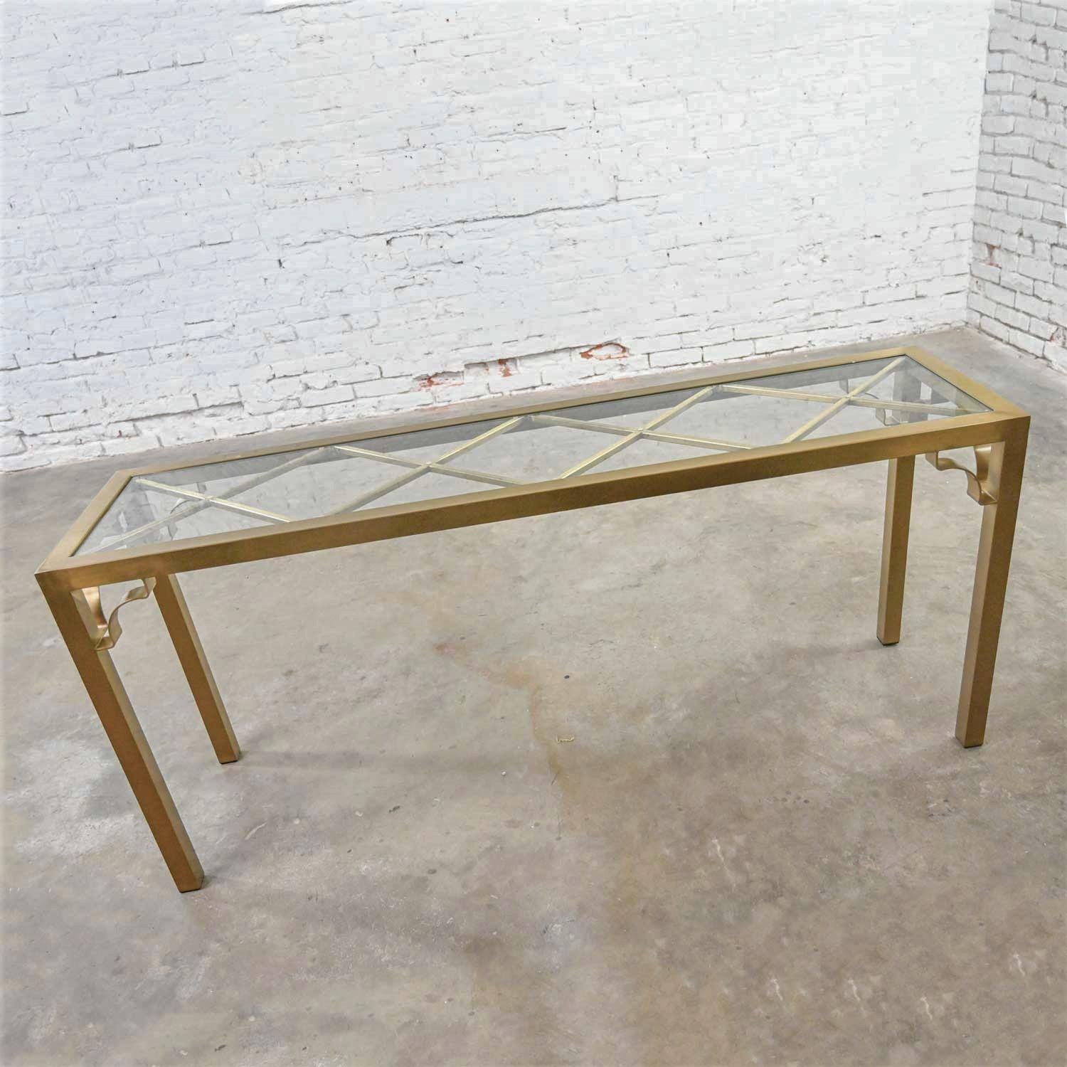Fabulous Modern or Hollywood Regency brushed brass plated Parsons’s style rectangle console table with an X design bracing for its glass insert top. Beautiful condition, keeping in mind that this is vintage and not new so will have signs of use and
