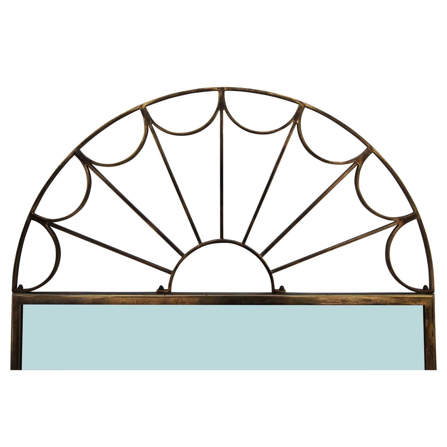 Modern Hollywood Regency rectangular mirror with a radiating golden brass arch attached to the top.