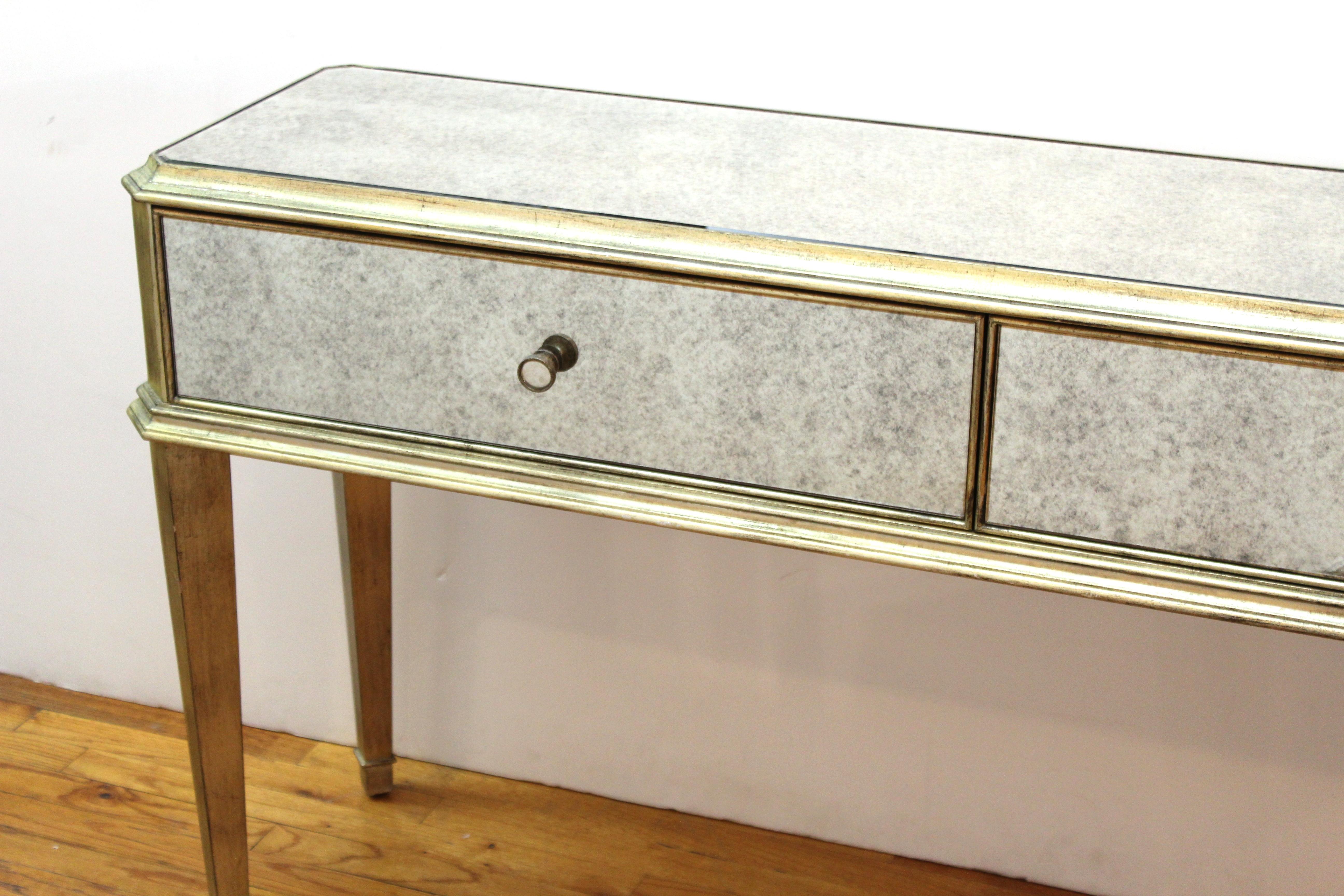 Modern Hollywood Regency console with drawers. The piece has mirrored surfaces and two drawers. In great vintage condition with age-appropriate wear and use.