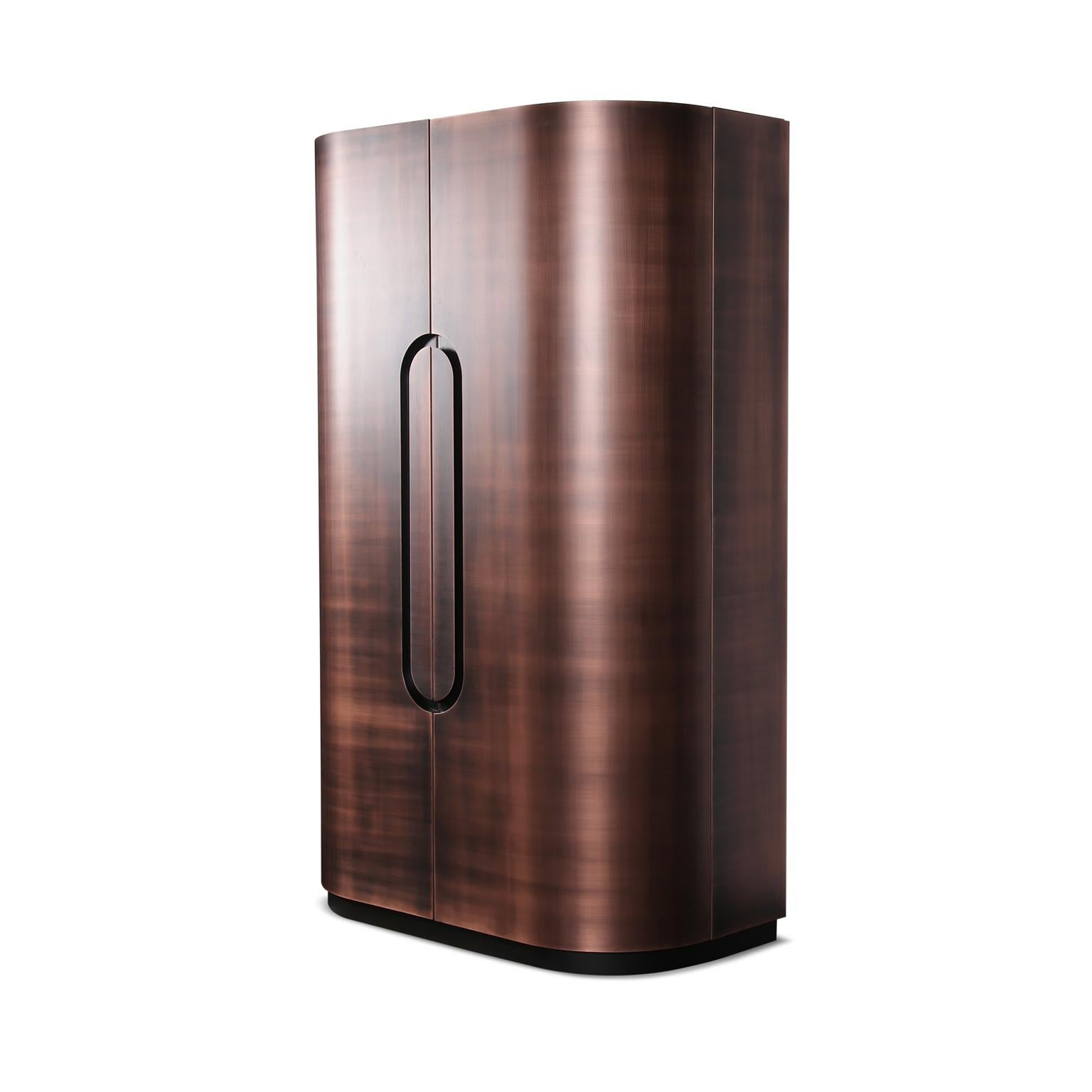 Exquisite custom bar cabinet, a true masterpiece that seamlessly blends sophistication and functionality. Immerse yourself in luxury with the darkened bronze metal finish that envelopes the exterior, creating a captivating aura of opulence. The