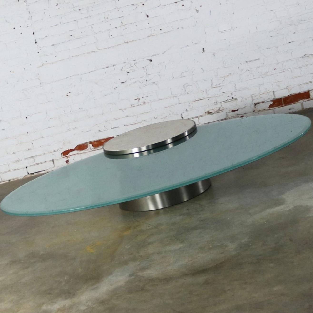 Stunning 21st Century Hoop cantilevered low cocktail or coffee table by J. Wade Beam for Brueton. Comprised of a cylindrical stainless-steel base with an ivory colored marble inset and a frosted oval glass top. Beautiful condition, keeping in mind
