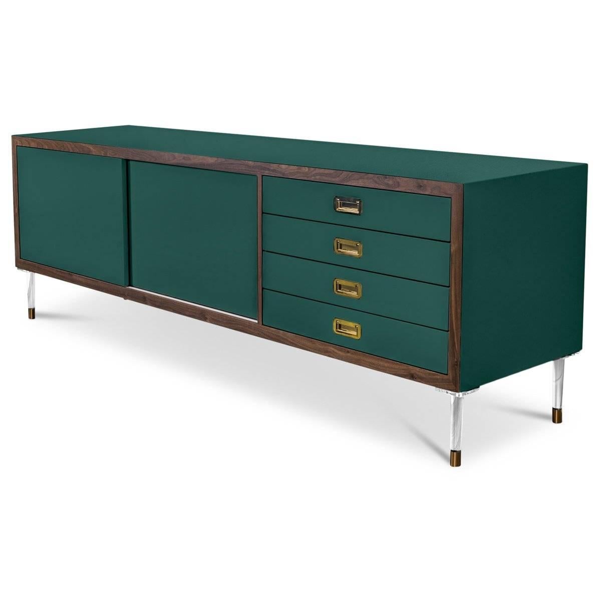Introducing our new St. Martin Credenza featuring two sliding doors and four drawers to maximize its functionality while still being stylish and chic. This retro-modern design features an oiled walnut trim, brass hardware, our famous Hunter Green