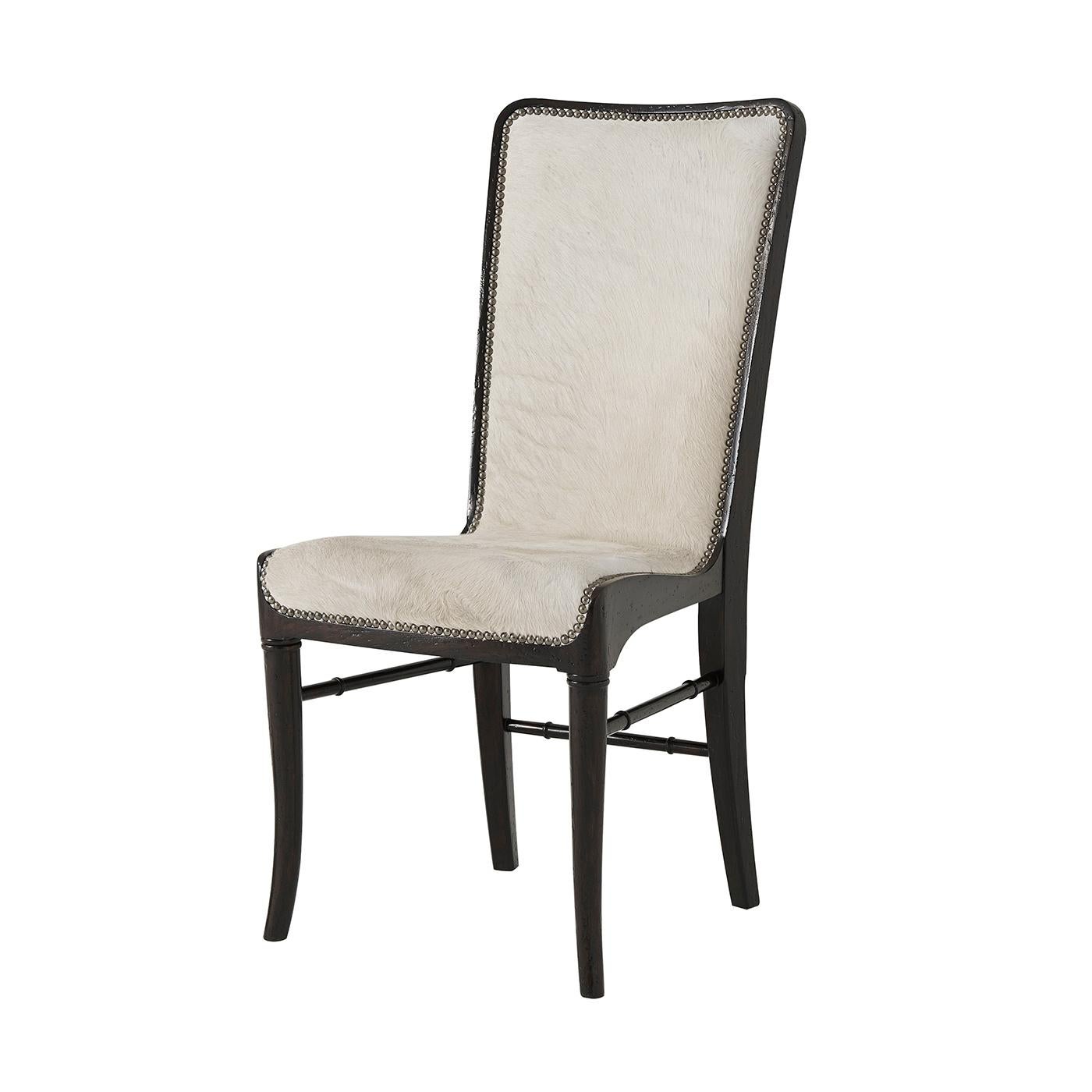 Modern mahogany dining chair with a dark finish, slung upholstered seat and back - upholstered in cream hyde leather - with nailhead trim and turned stretchers.

Dimensions: 19.5