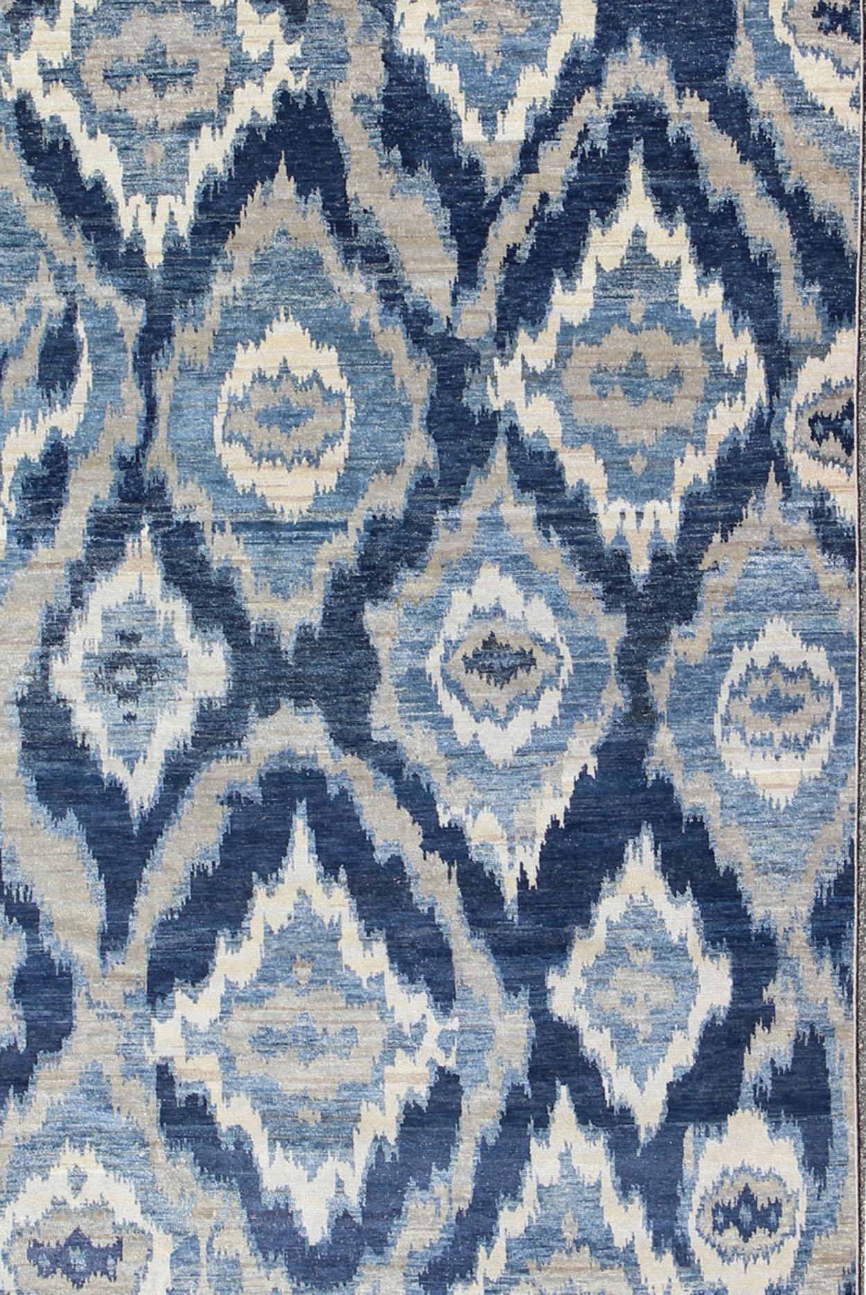  Large Modern Ikat Fine Rug With All-Over Geometrics in Blue, Taupe and Ivory  This Modern Ikat Rug with beautiful design in navy, and taupe colors is well suited for contemporary setting as well as any transitional room.

 Measures: 10'0 x 14'0. 

