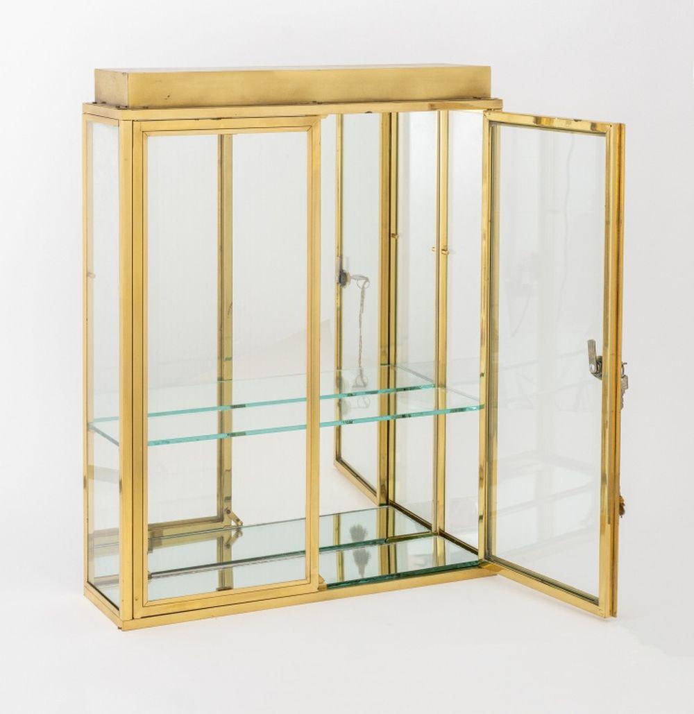 Modern Illuminated Brass and Glass Display Cabinet, two doors opening to two glass shelves with mounted light to the interior top. 25.5