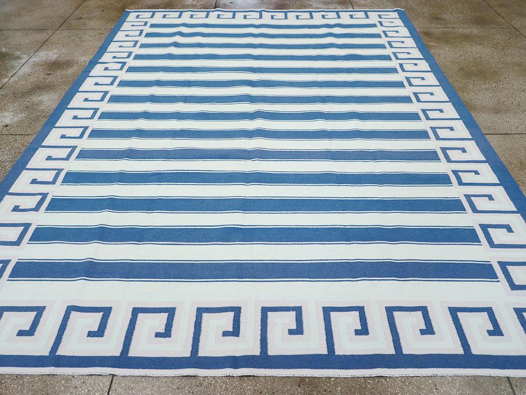 This 21st-century Indian flatweave Dhurrie rug, measuring 9' 4