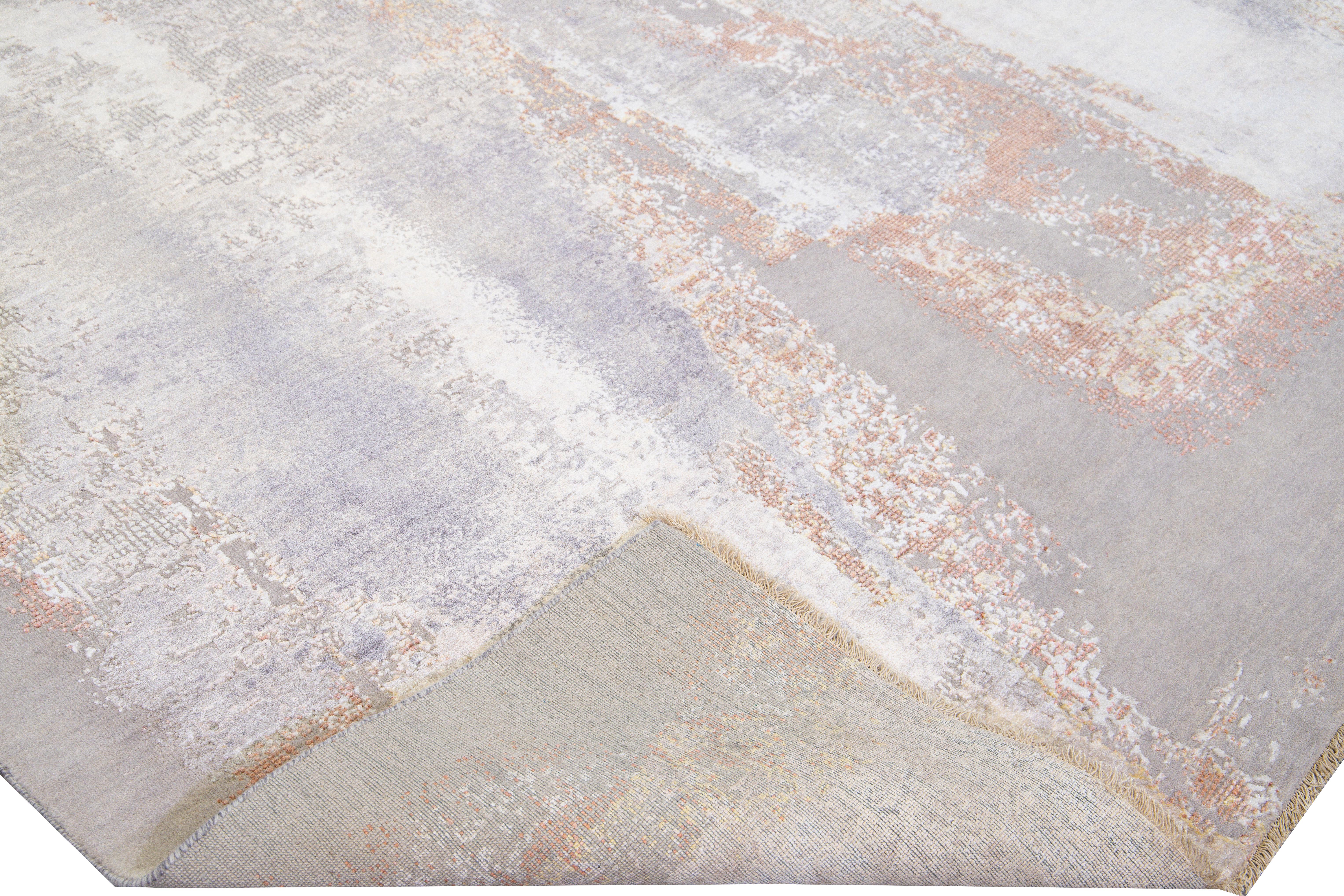 Beautiful modern Indian hand-knotted wool and silk rug with a gray and beige gradient field. This Modern rug has copper and ivory accents a gorgeous layout expressionism abstract design.

This rug measures: 9'1