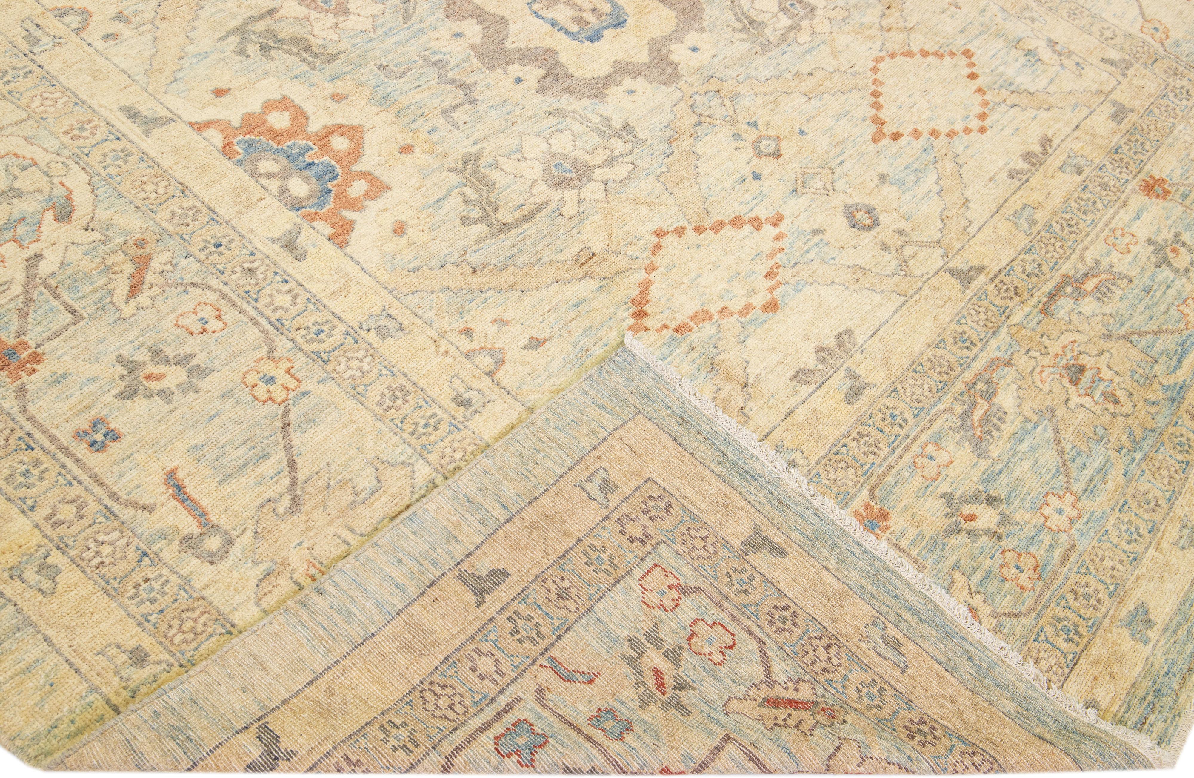 Beautiful modern hand-knotted wool rug with a Blue color field. This Indian Piece has beige, rust, and blue accent colors in a gorgeous all-over floral design.

This rug measures: 10'1