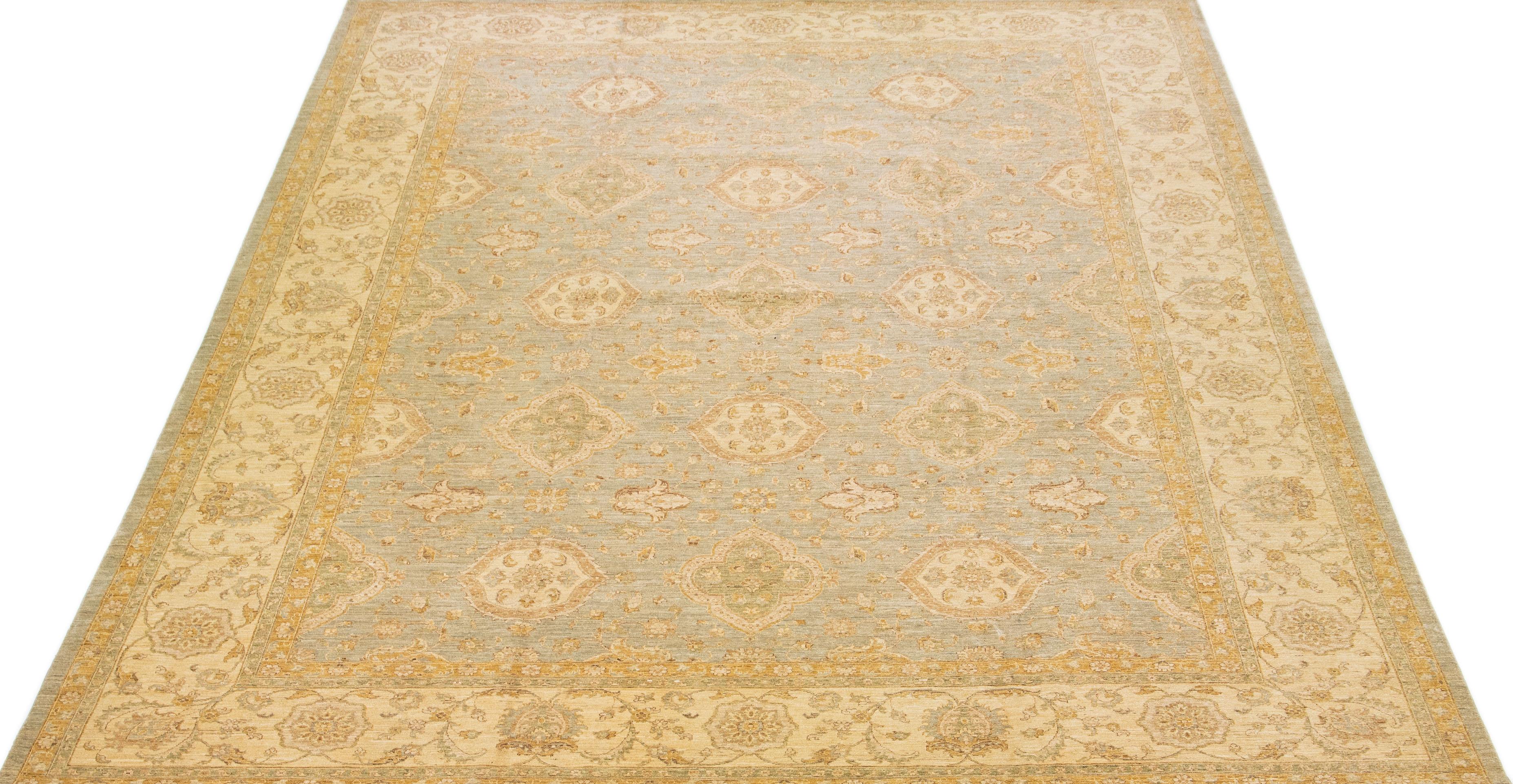 Beautiful modern Persian style Indian hand-knotted wool rug with a gray color field with brown and green accents on a Classic Botanica floral design.

This rug measures 13'3