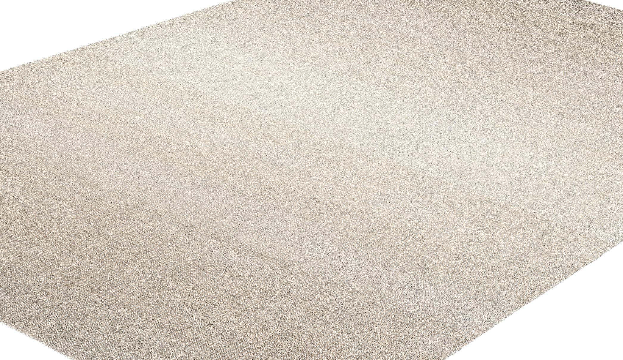 Questo tappeto moderno, realizzato in India con la migliore lana Merino della Nuova Zelanda, incarna il perfetto equilibrio tra lusso e semplicità. Caratterizzato da un morbido motivo a gradiente in tranquille tonalità neutre, si integra
