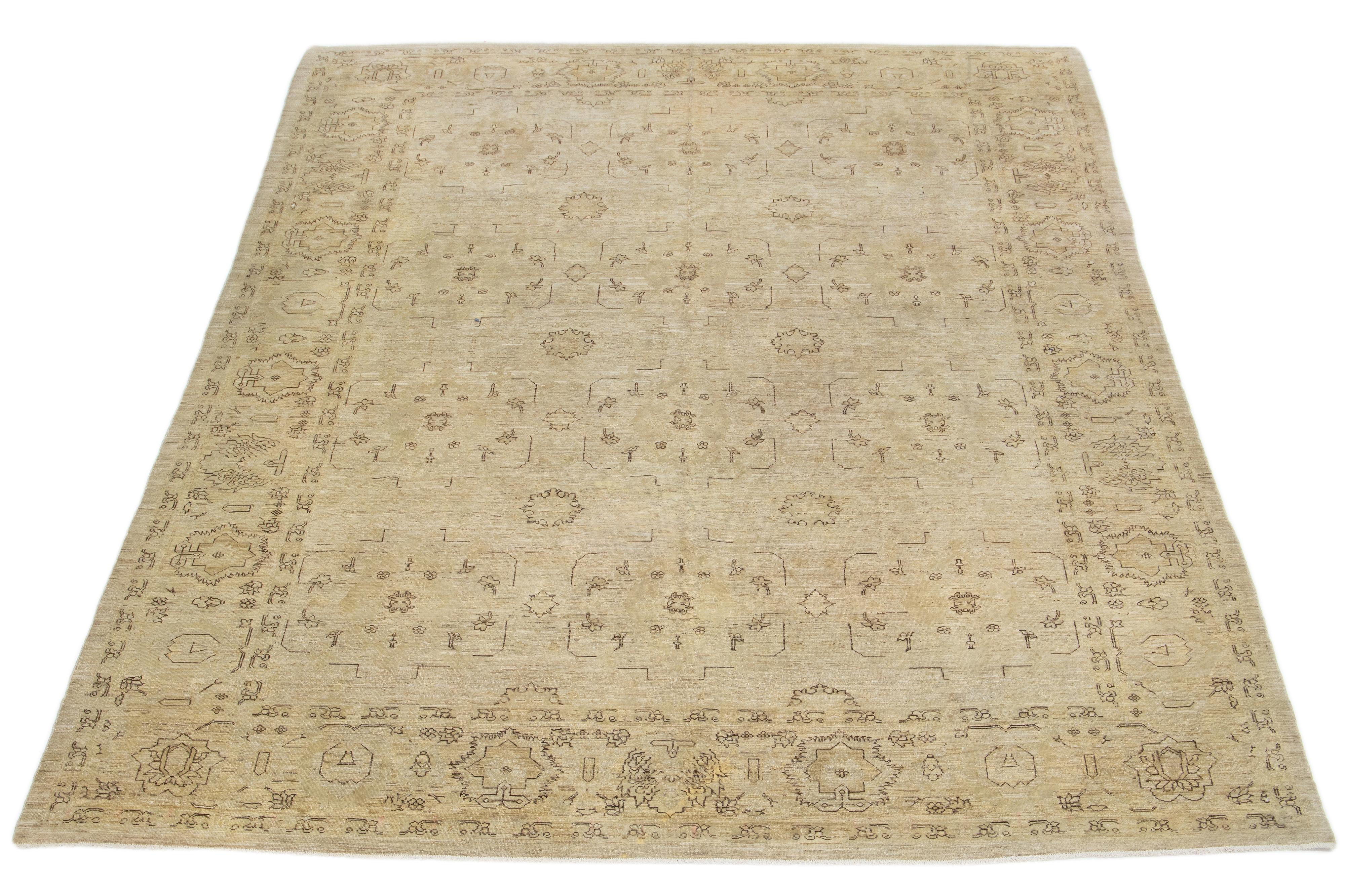 This modern hand-knotted wool rug showcases an enchanting beige-tan base complemented by brown and gray details arranged in a pattern throughout.

This rug measures 7'10