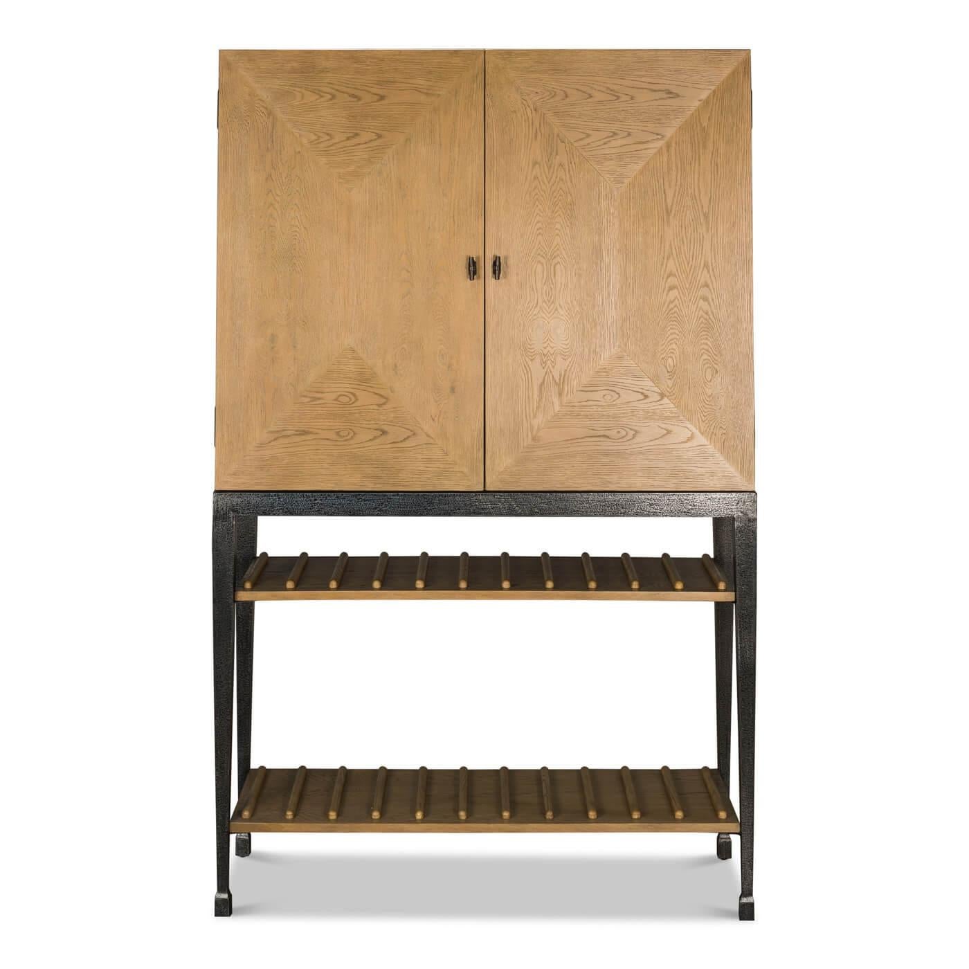 Modern Industrial bar cabinet, crafted of oak and is supported on an iron base. 

The top cabinet features finely crafted beveled doors in oak and oak veneer. When opened, the cabinet reveals storage for wine glasses, glass shelves for display and