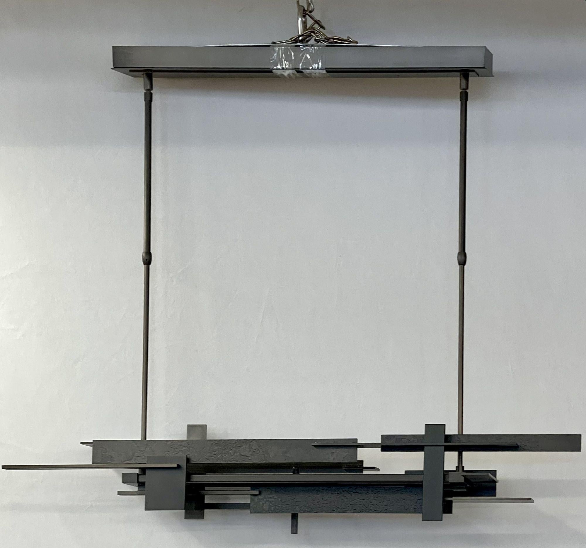 Hubbardton Forge Planar linear chandelier, dark smoke pendant ceiling light, LED, 2000s
 
Influenced by Frank Lloyd Wright's visionary Fallingwater home from the 1930s, the horizontal Planar LED Pendant delivers clean, modern, gravity-defying