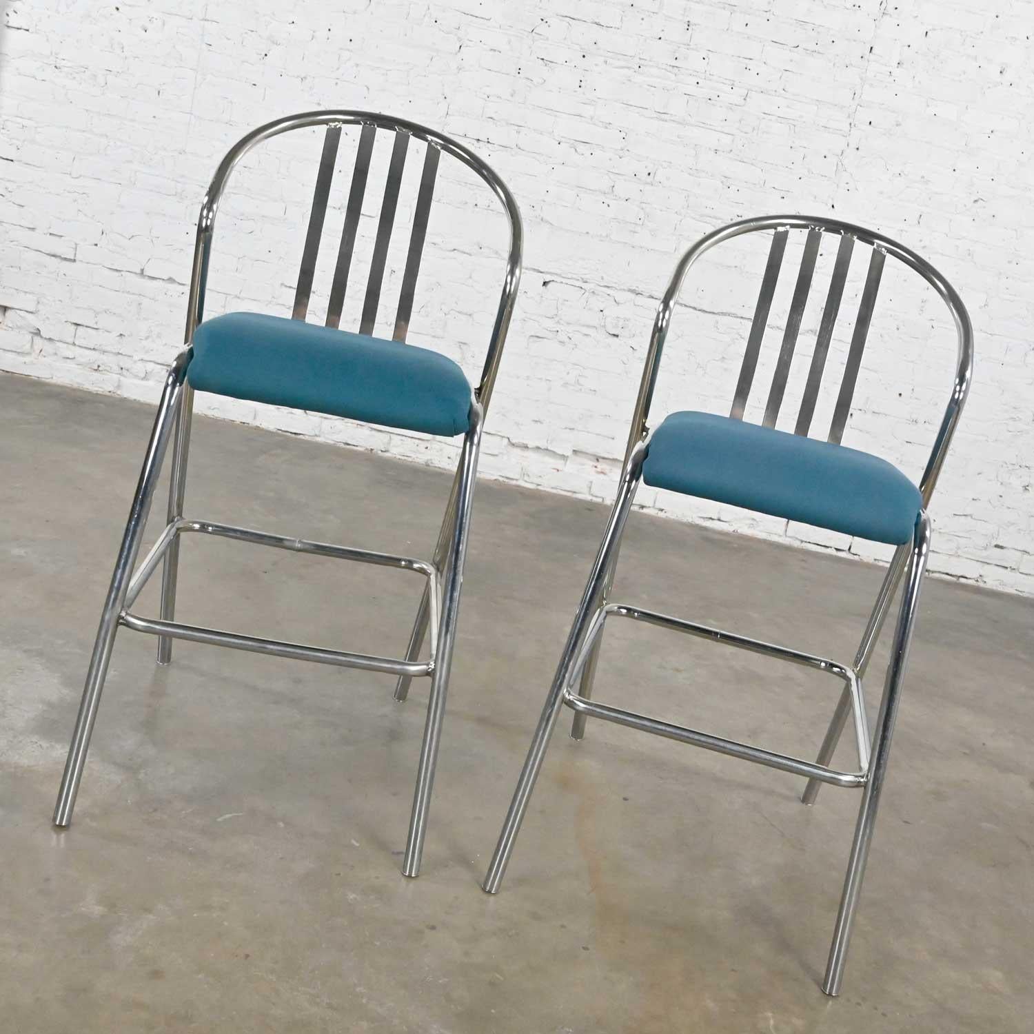 Fabulous Modern Industrial pair of bar height barstools comprised of chromed steel frames, blue gaberdine-like fabric seats, and new chrome tube cap feet. Beautiful condition, keeping in mind that this is vintage and not new so will have signs of