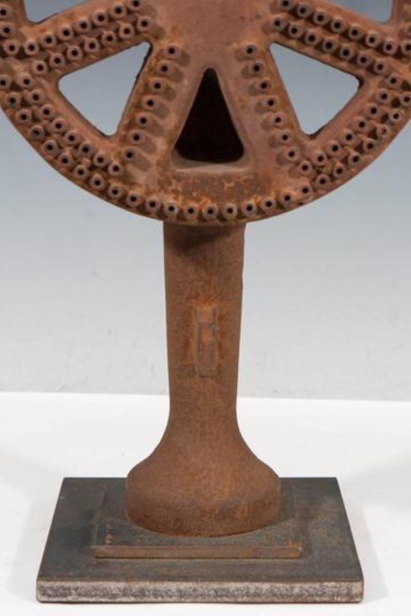 Modern Industrial style sculpture of an iron wheel on a stand, reflecting Machine Age aesthetics. 16
