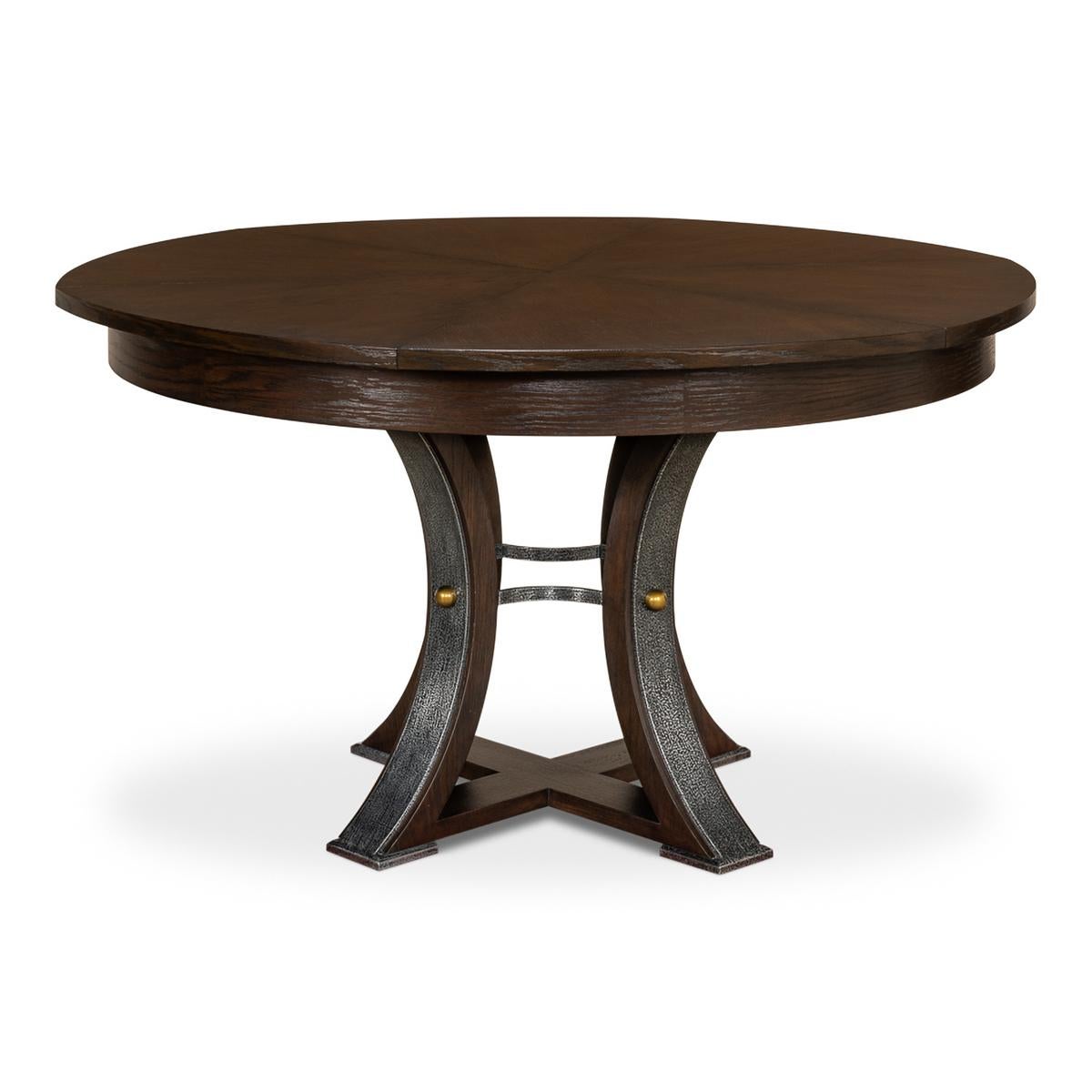 A modern industrial style round extending dining room table. Wire brushed oak top in our Burnt Brown finish with gunmetal iron accents to the simple geometric form base. The table opens and extends to 70