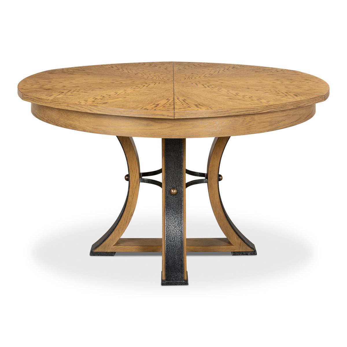 A modern industrial style round extending dining room table. Wire brushed oak top in our Heather grey finish with gunmetal iron accents to the simple geometric form base. The table opens and extends to 70