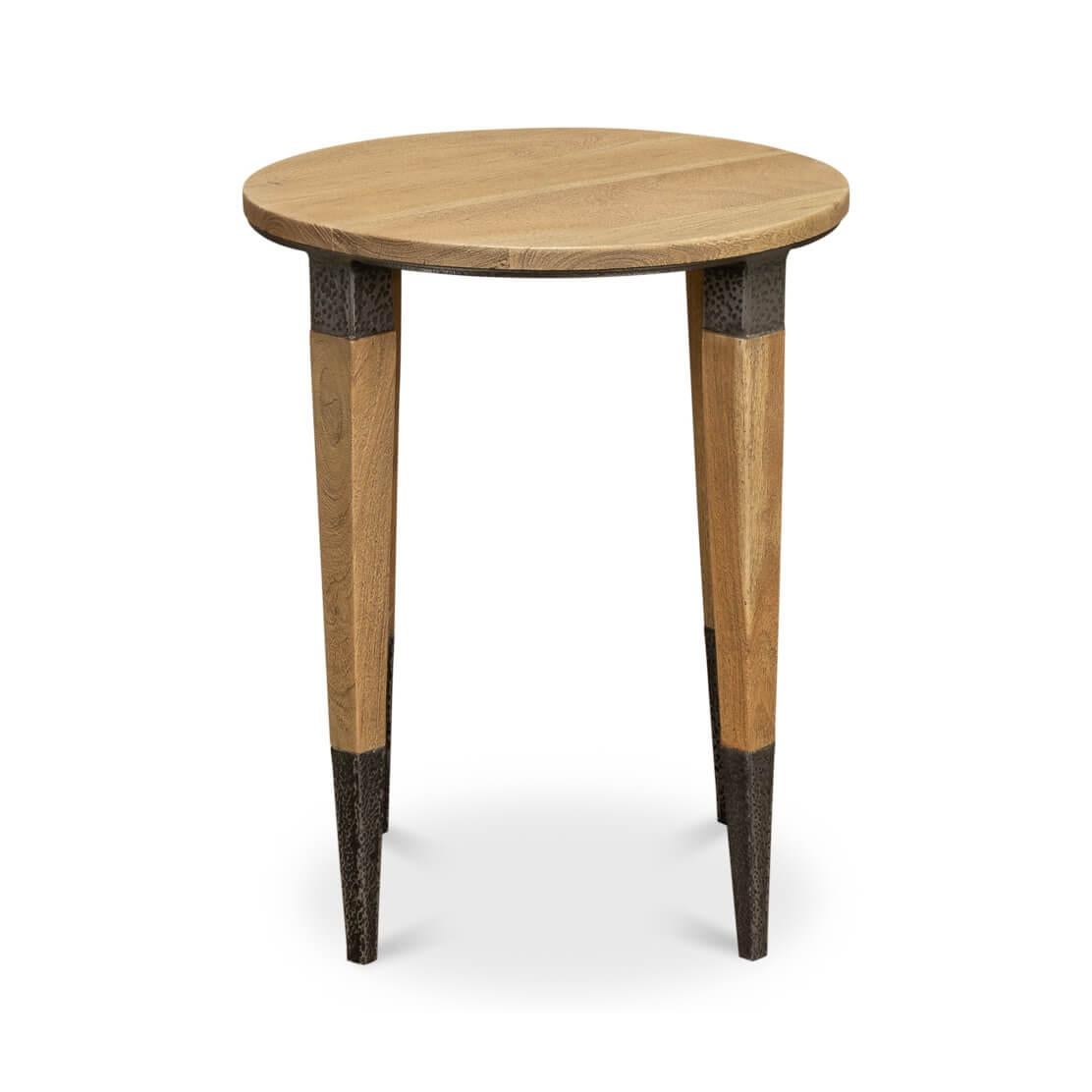 This unique piece boasts a circular top crafted from natural wood in our wheat finish, showcasing the beauty of its grain and warm tones.

What truly sets this table apart are the distinctive legs. Each one tapers down in an elegant taper, finished