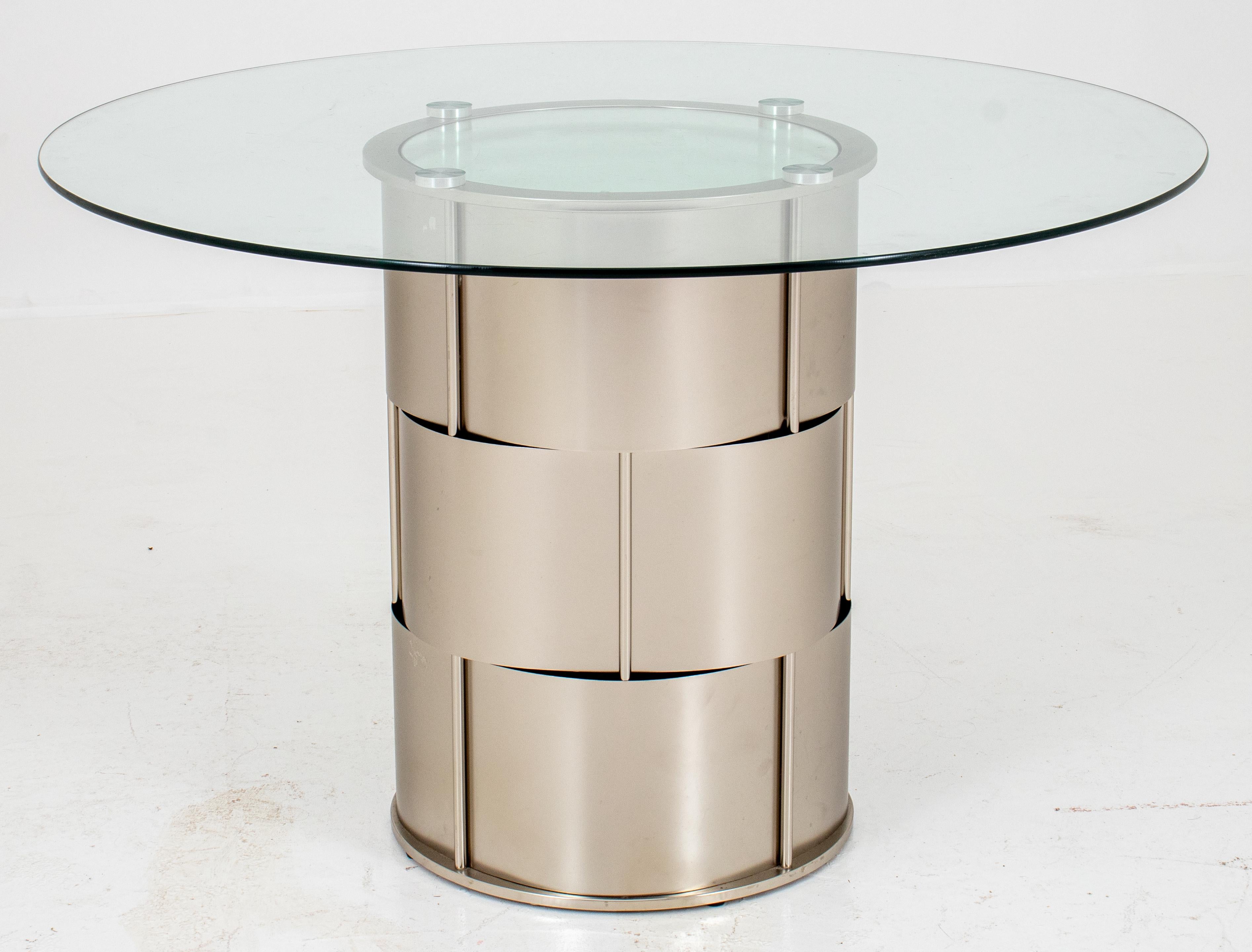 Modern industrialist steel drum table with three chromed metal plates woven betwixt cylindrical rods, a mirror top and glass surface. Measures: 30.5