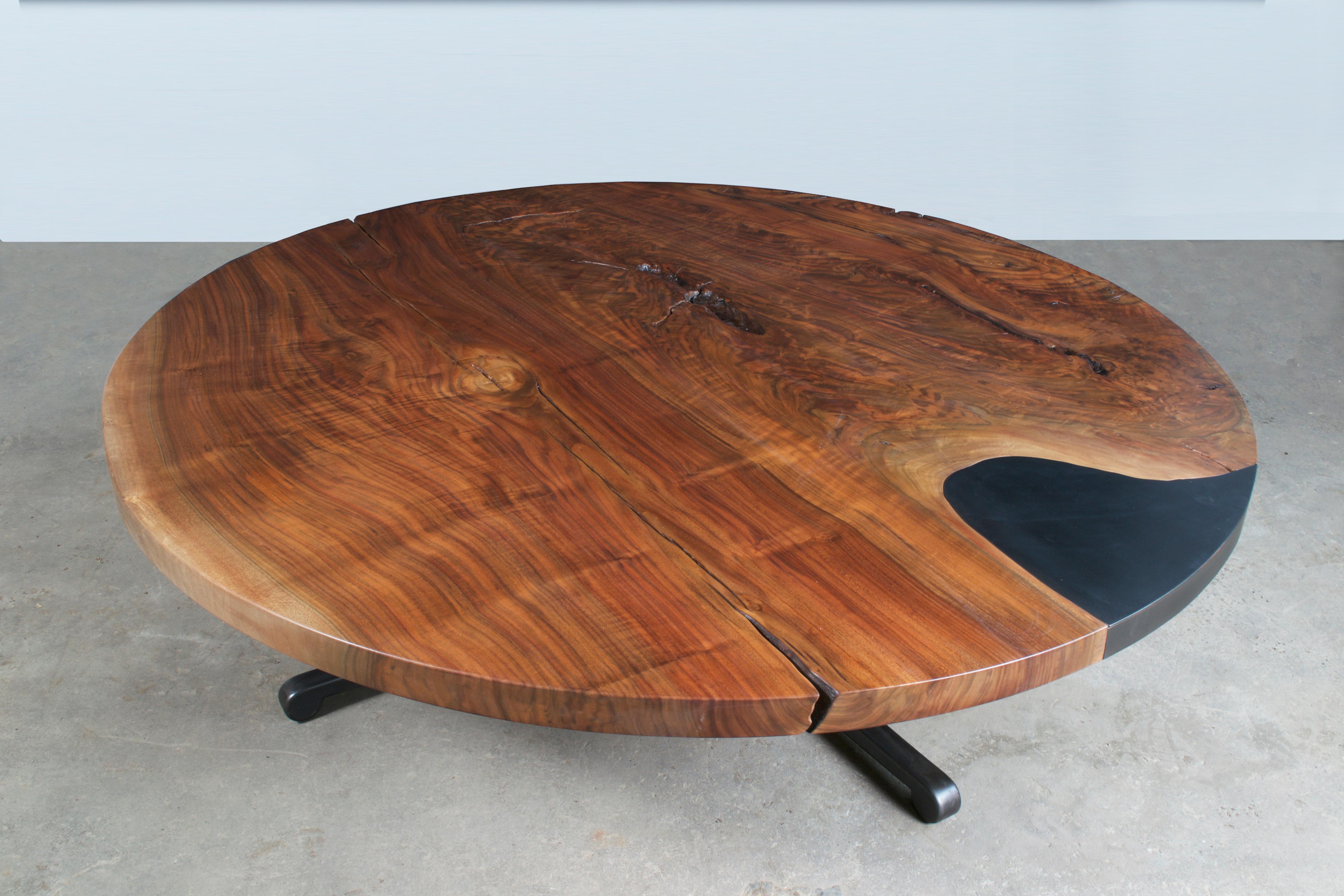 A single slab of highly figured walnut lends a celestial effect to the top of this exquisite Serif Coffee table. Grain matched steel inlay, with removable steel plate revealing hidden storage. Signature Serif leg, shown in raw flame cut finish.