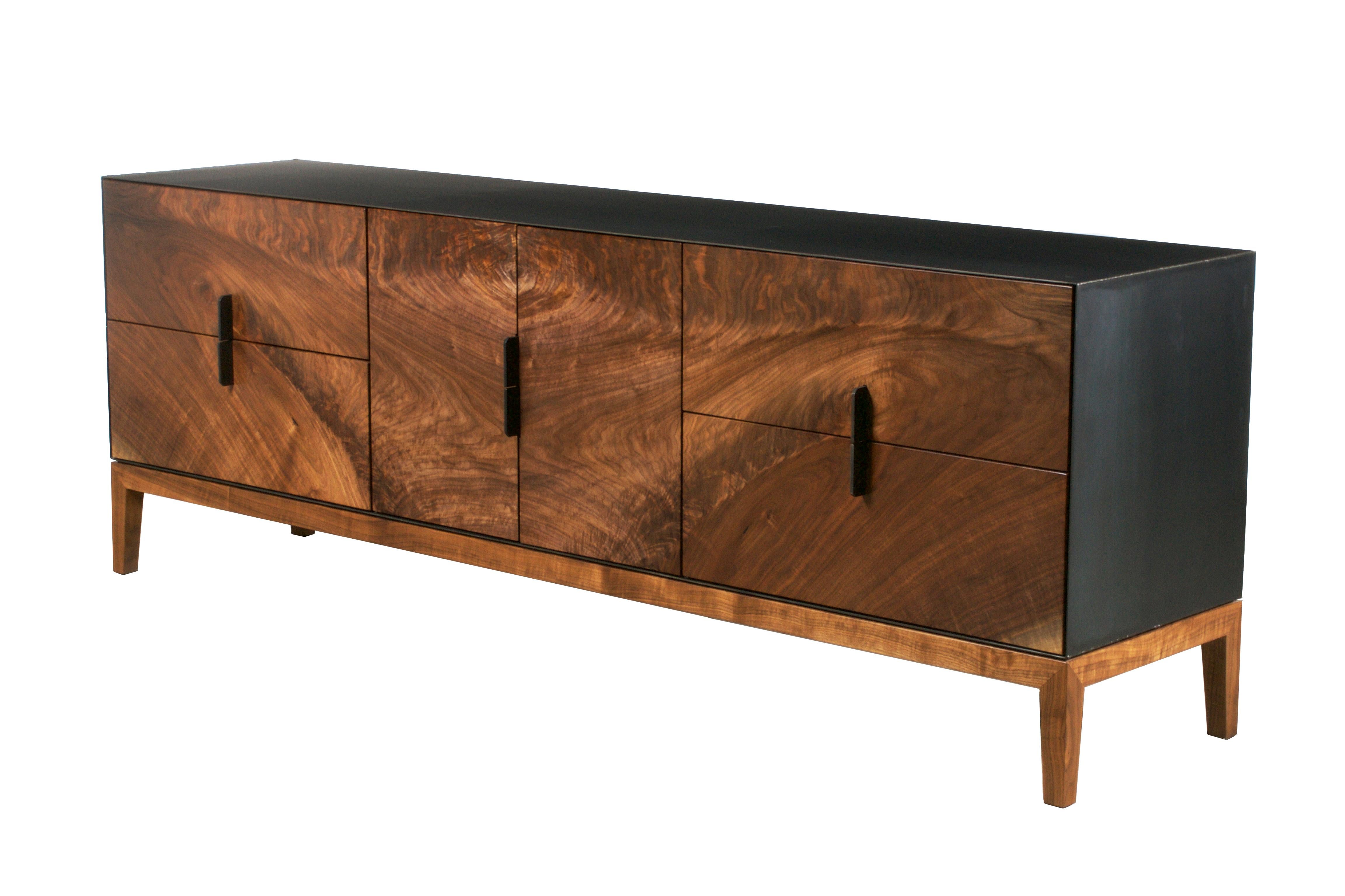 Bookmatched pieces of highly figured solid walnut make up the front of the limited edition taper series media cabinet. Center doors open to reveal electronics storage, complete with cable management, while two pairs of drawers store media on either