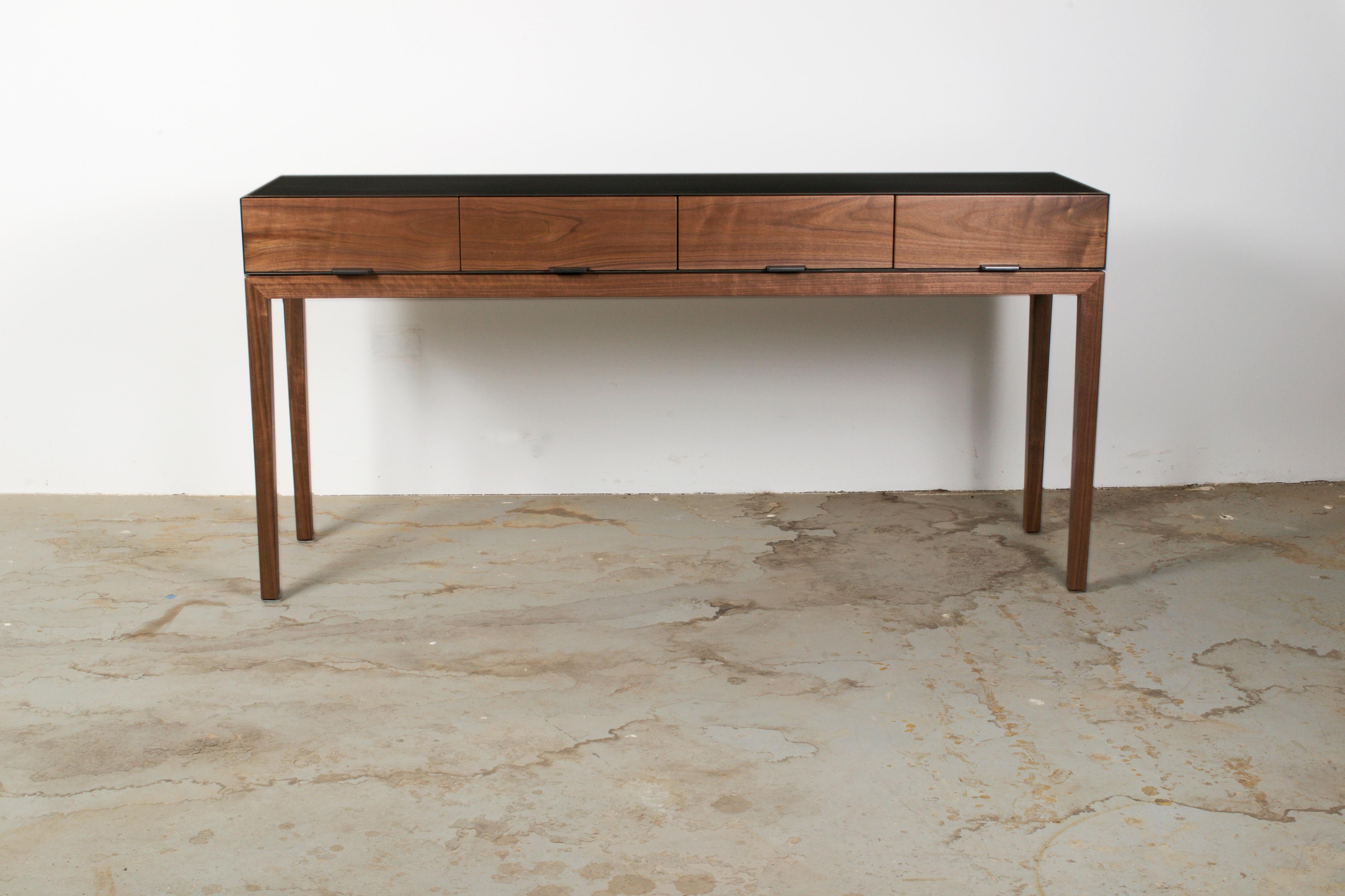 Taper series console with grain matched drawers, featuring a Hot Rolled steel case and tapered legs. Shown in Walnut, with custom steel pulls. Drawers on luxe soft close under-mount glides. 

Measures: 66